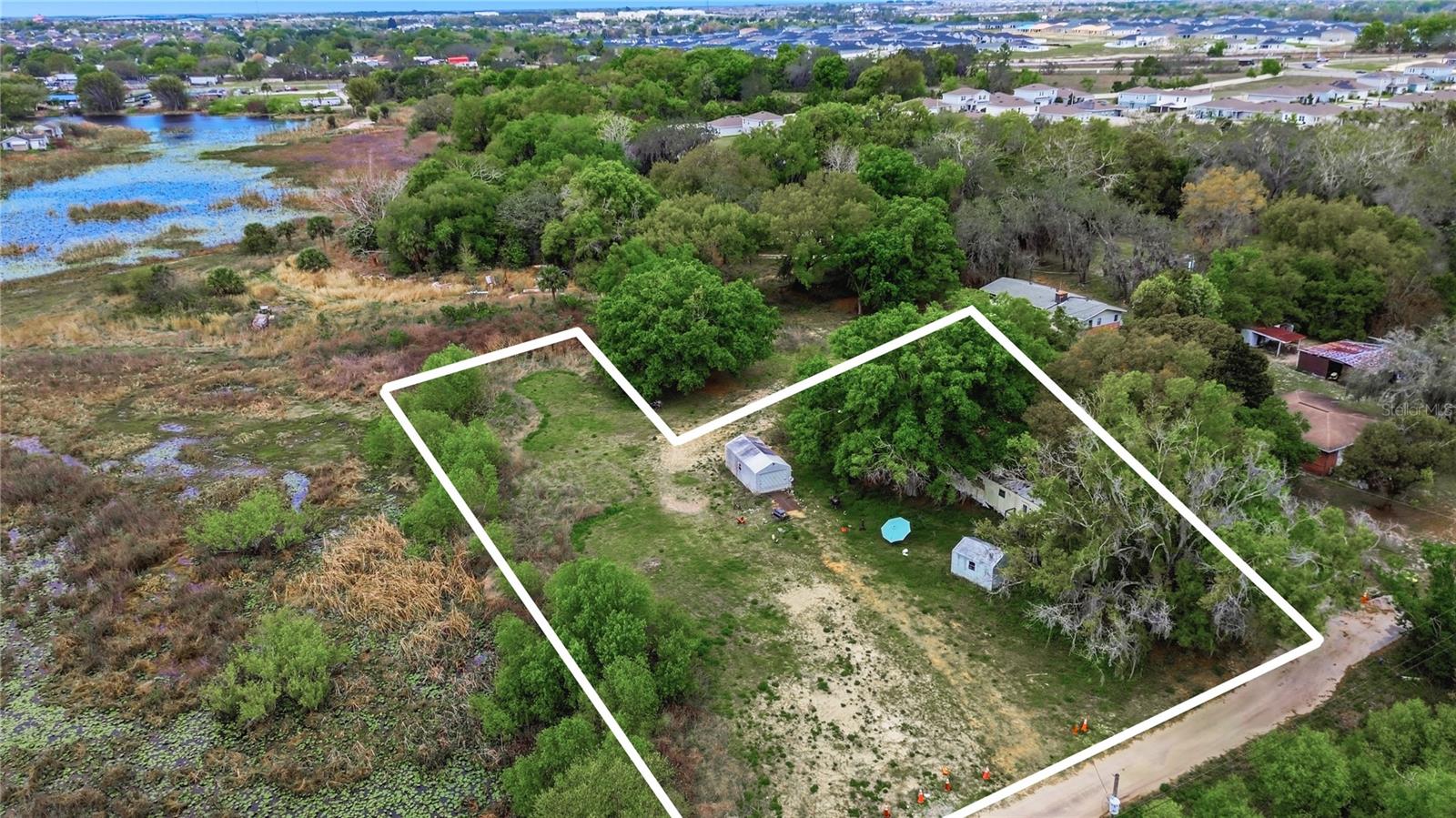 A Hidden Slice of Florida Paradise on 1.18 Acres 

Tucked away from the hustle and bustle, this peaceful 1.18-acre homesite offers the perfect blend of privacy, nature, and opportunity. Surrounded by natural greenery and serene wetland views, you’ll enjoy a quiet setting with no rear neighbors—your own private retreat right here in Davenport.

The property is mostly cleared with level ground, making it an ideal canvas to build your dream home or create a custom homestead tailored to your lifestyle. Two storage sheds (12x20 and 10x10) provide immediate functionality, while an existing mobile home is on site seller is willing to remove it if the buyer coordinates haul-off.

Whether you're looking to build, invest, or simply enjoy a little extra space and tranquility, this property offers endless potential in a rapidly growing area.
