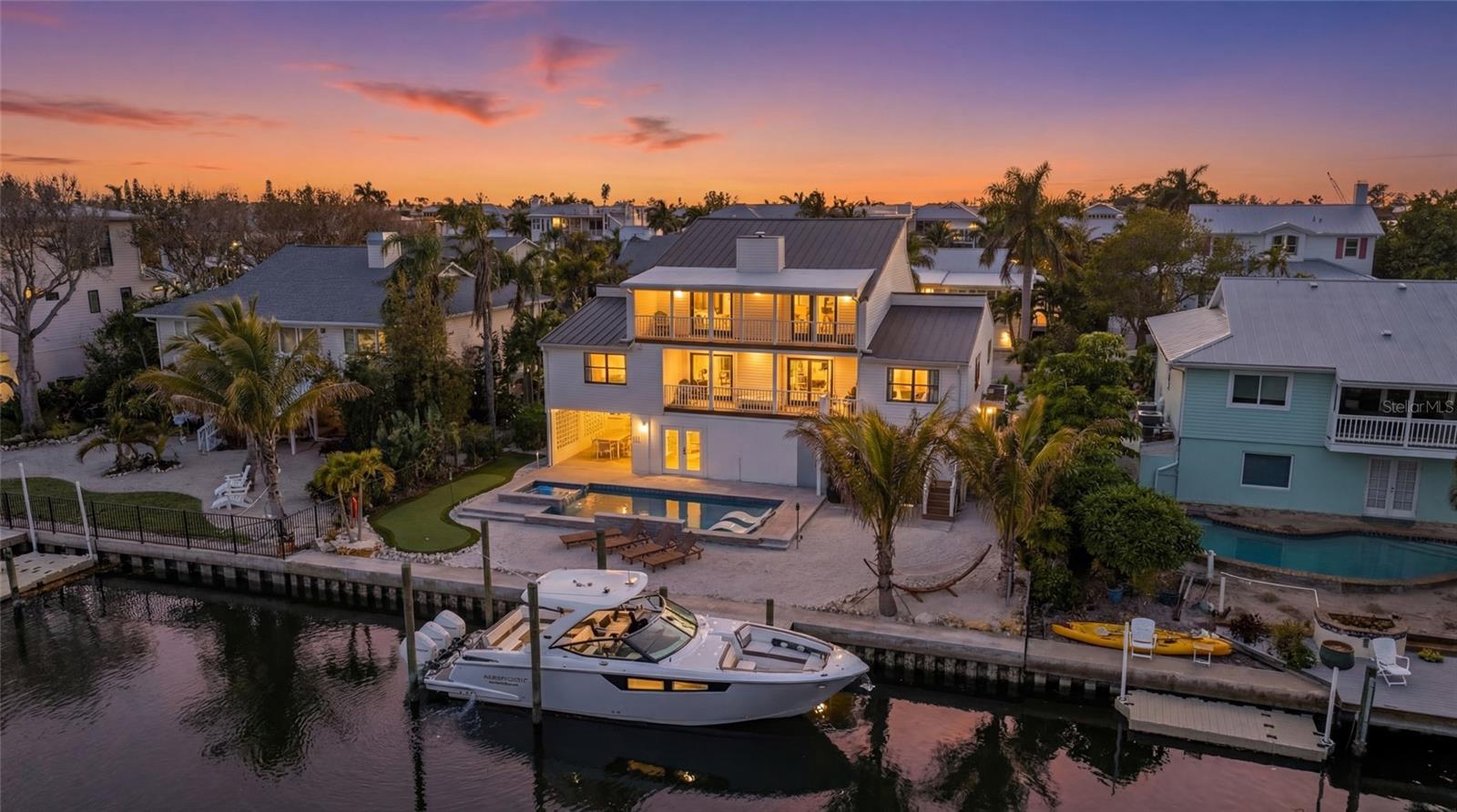 Welcome to 519 Loquat Drive, an exceptional waterfront retreat in the heart of Anna Maria. Positioned on a deep, boatable canal with direct, unobstructed access to Bimini Bay and Tampa Bay, this 4-bedroom, 4-bath residence delivers luxury, location, and a lucrative income opportunity, exceeding $200,000 annually - on pace to surpass $300,000 this year!

Completely remodeled in 2025 and offered fully furnished including a sauna, gym, and games, this turnkey home spans over 2,600 square feet and an additional over 1300 plus square feet of non-conforming flex space which features a game room, gym, outdoor kitchen and more. The interior includes luxury vinyl flooring, quartz countertops, hurricane-impact sliders, and an open-concept design built for entertaining. The chef’s kitchen showcases stainless steel appliances, and abundant cabinetry, seamlessly flowing into the living and dining areas with a statement fireplace.

This home features four bedrooms, including three with private ensuites. Two full primary ensuites showcase spa-inspired baths, generous closets, and private balcony access. Additional bedrooms offer comfort for family or guests. A dedicated laundry room with custom built-ins, ample storage, and a separate owner’s garage add convenience and functionality.

Outdoor living is elevated with a brand-new heated pool and spa, all-new pool equipment, putting green, outdoor kitchen, and outdoor shower. Enjoy immediate boating access, with no bridges - to open water. Trex stairs and balcony decking ensure durability and low maintenance.

Upgrades include a new metal roof, brand-new seaball, brand-new dock, new landscaping, one brand-new AC system plus a new mini-split, and a fully renovated interior from top to bottom. Currently operating as a successful Airbnb with strong rental history, this property is equally suited as a high-performing investment or private waterfront residence.

Located moments from the sugar-white sands of Bean Point Beach and the shops and dining of Anna Maria, this home offers effortless access to the best of island living!
