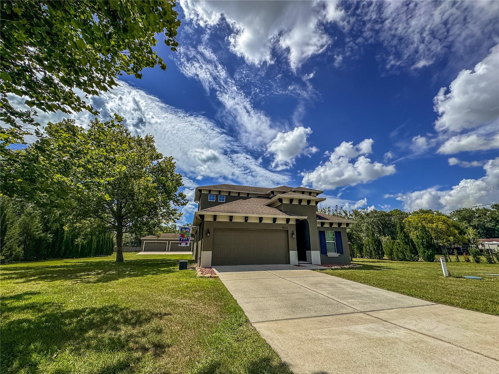 Spacious 4-bedroom, 3-bath home on 1.2 acres with a 2-car garage and an impressive 25x38 detached concrete block workshop/garage, offering exceptional flexibility for car enthusiasts, hobbyists, or those needing extra storage space. Located in desirable Land O' Lakes, this property combines room to grow with the freedom of no HOA, no deed restrictions, and no flood insurance requirements.
Inside, the 2,184-square-foot floor plan is designed for comfort and versatility, featuring cozy living areas and a unique upstairs retreat complete with a bedroom, full bathroom, and bonus room that is ideal for guests, a home office, or multi-generational living. An enclosed patio provides additional space to relax and enjoy year-round.
Outdoor living is enhanced by the expansive 1.2-acre homesite with AG zoning and a second gated driveway leading to the detached 4-car concrete block garage/workshop. Equipped with a 200-amp electrical panel, separate meter, and 12-gauge wiring throughout, this space offers endless possibilities for projects, recreational vehicles, or business use. Gather around the firepit with family and friends and enjoy the privacy and open space that this property provides.
Conveniently located in the heart of Land O' Lakes, you'll enjoy easy access to shopping, dining, parks, and major roadways while still experiencing the peace and space of country-style living.
With its acreage, versatile floor plan, exceptional workshop space, and unrestricted lifestyle, this property offers a rare opportunity to enjoy the best of Land O' Lakes living.