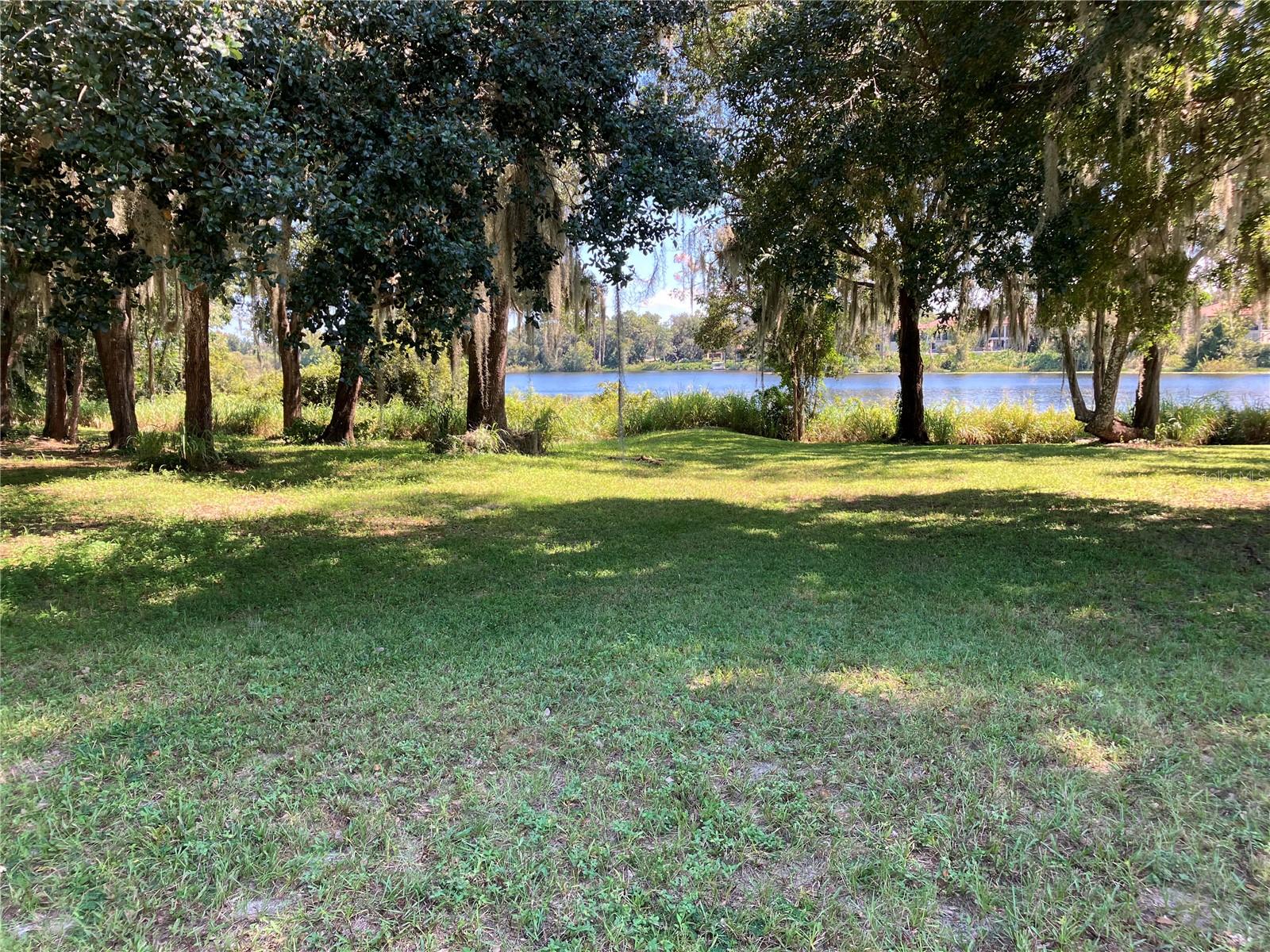 Beautiful subdivision Lakes of Deland welcomes you to build your next home on this mostly cleared waterfront lot on Horseshoe Lake.  A few oak trees remain, but center of lot is cleared. Enjoy the nice breezes over the water in this 20 year old community.  No gas powered boats allowed on lake but you may have battery operated or canoes. Take afternoon walks on the paved walking trail throughout the gated 55+ community.   No feasibility studies have been done yet for this lot, but survey (see pics) was done over 10 years ago by Efird Surveying in Orange City.  Front of lot measures 61 feet wide, while back (waterfront) is 82 feet.  Depth is 117 on one side and 118' on other.  Almost 1/4 acre lot in community of nice larger homes with tile roofs.  HOA is $135 /month.