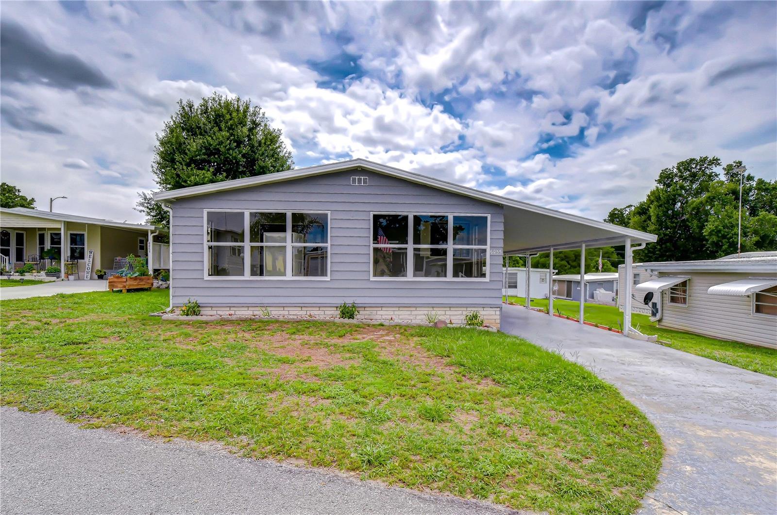 Welcome to easy Florida living in the desirable 55+ community of Green Hills Estates! This well-maintained 1984 manufactured home offers 1,248 square feet of comfortable living space plus an additional 208-square-foot Florida room, creating plenty of room to relax, entertain, and enjoy the Sunshine State lifestyle. Step inside and you'll immediately appreciate the light and bright kitchen featuring crisp freshly painted cabinetry and brand-new stainless-steel appliances. The dining area is conveniently located just off
the kitchen and flows seamlessly into the spacious living room, creating an open floor plan that makes everyday living and entertaining a breeze. The home features two generously sized bedrooms with ample space for your furniture and personal touches. Brand-new flooring extends throughout the entire home, offering a fresh, updated look with easy maintenance and absolutely no carpet. An interior laundry room adds convenience, allowing you to do laundry comfortably without stepping outside. Outside, you'll
find a covered carport for protected parking and a storage shed perfect for tools, holiday decorations, and additional storage needs. The inviting Florida room is the perfect place to start your morning with a cup of coffee or unwind in the evening while enjoying Florida's beautiful weather. Ideally located near shopping, local restaurants, medical facilities, and historic downtown Zephyrhills, you'll have everything you need just minutes from home. Whether you're searching for the perfect winter retreat, looking to
downsize, or planning for an early retirement, this charming home offers affordability, comfort, and convenience in a welcoming community. Opportunities like this don't last long, come discover why so many love calling Green Hills Estates home.