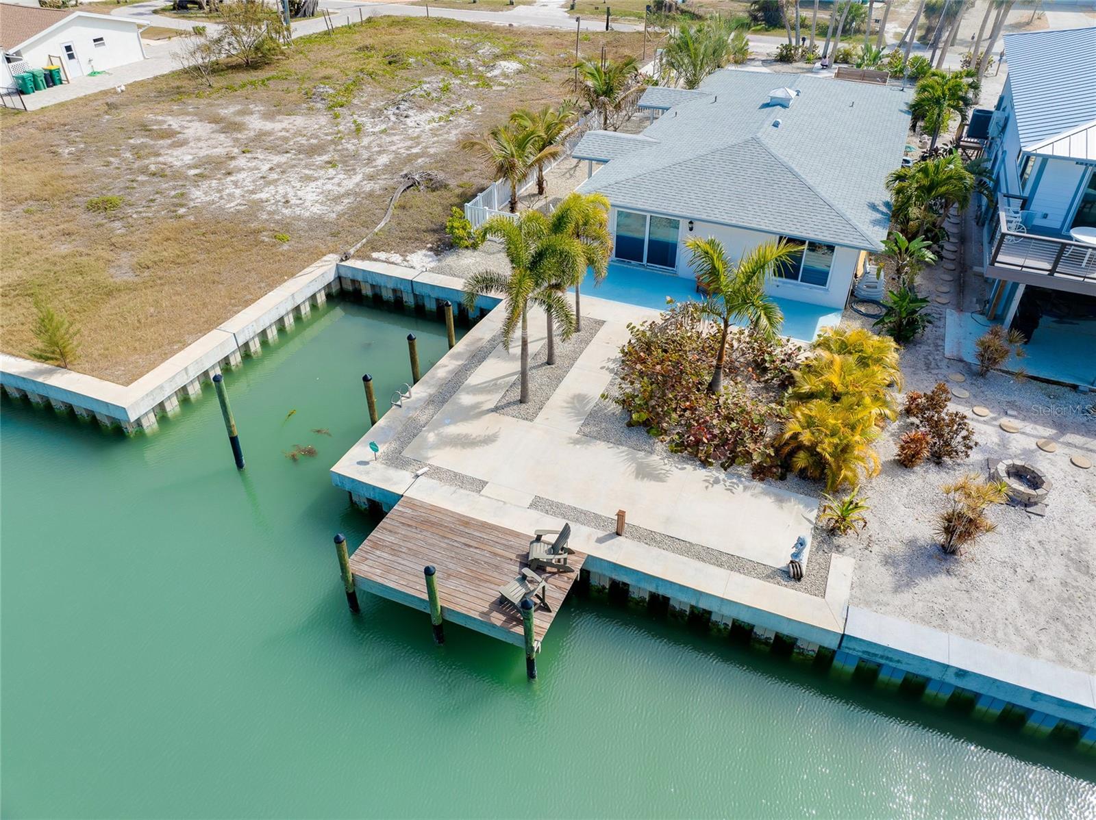 Located on the highly desirable southern tip of MANASOTA KEY, which was recently named one of the Best Places to Retire by Travel & Leisure Magazine, 170 Mockingbird Lane presents a rare opportunity to own WATERFRONT property on one of only two CANALS serving this exclusive beachside community — a true boating paradise for anglers and shelling enthusiasts alike — with fast access to Stump Pass and the GULF. Situated on a generous 50’ x 160’ lot, this property features a 30’ PRIVATE BOAT BASIN and a newer SEAWALL installed in 2023, offering DIRECT ACCESS TO LEMON BAY and a short boat ride through deep water and mangroves to some of South West Florida’s best fishing. A few features you'll be sure to enjoy are the PRIVATE TEAK WOOD OUTDOOR SHOWER, canal side TEAK DOCK (8' x 15') and the convenient dockside hose bib , perfectly located so you can wash your boat and gear after a long day out on the water. Enjoy an incredible sunrise coffee from the dock and step onto your boat, kayak, or paddle board for an amazing day on the water. Take a short walk to Stump Pass State Park or across Manasota Beach Road to the neighborhood’s beautiful beach access for an incredible Florida sunset. The existing residence was a 2-bedroom, 2-bath home designed to capture incredible canal views with tropical landscaping and ample hardscape designed to enjoy tropical breezes and the relaxed charm of coastal living. The home was affected by the hurricanes of 2024 and is now ready to be restored to its former glory — or removed to make way for a new, elevated coastal contemporary masterpiece that maximizes views, outdoor living, and modern design. Whether you envision renovating the original footprint or building a brand-new waterfront retreat, the value here is in the prime canal-front location, protected boat basin, and new seawall — all in one of Manasota Key’s most coveted boating neighborhoods. Why pay expensive marina fees or monthly storage costs when you can keep your boat and trailer right at home for free? Enjoy the convenience of having it ready whenever you are — no extra bills, no long-term contracts, and no waiting on access. This is a rare chance to create your ideal waterfront lifestyle in a setting that truly captures the essence of Southwest Florida coastal living. As an added bonus, the two adjacent properties are also for sale by a separate land owner. Potential to combine the three lots certainly exists.