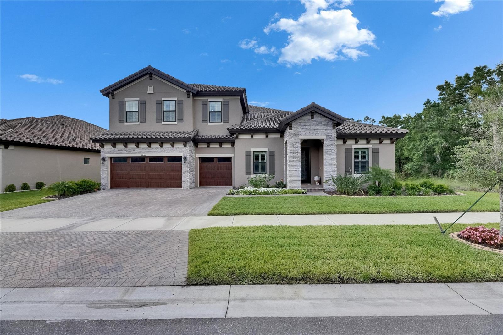Less than THREE YEARS OLD!!! Welcome to one of the most spacious and upgraded POOL/SPA HOMES in Hawkstone's private, gated community. Wait until you see this one! Nothing will compare to the LOVE put into this home! Sellers have put in OVER $200K in UPGRADES! This custom-built Key West II model spans nearly 4,700 square feet and features 5 bedrooms, 4 bathrooms, an oversized office/den, a versatile den, a loft, and a pool/spa. Every detail of this residence has been meticulously curated. This stunning oasis is situated on a large lot with conservation views to the rear and to the side, with only one neighbor to your left. With soaring 12-foot ceilings on both levels and tray ceiling accents, the home boasts oversized windows that enhance its grandeur. The craftsmanship throughout is exceptional, creating an atmosphere of elegance and spaciousness. The owner has spared no expense on this impressive custom home, which includes over $200,000 in builder upgrades. Upon arrival, you'll be captivated by the charming craftsman exterior, featuring a professionally sealed tile roof and paved driveway that leads to a spacious three-car garage. The heart of the home is the grand gourmet kitchen, which includes a large extended island perfect for entertaining. Custom cabinetry, premium quartz countertops, and top-of-the-line stainless steel appliances, including a natural gas cooktop, wine cooler, and farmhouse sink, make it a haven for culinary enthusiasts. The kitchen seamlessly flows into the great room, creating an ideal gathering space. Escape to paradise in the screened-in pool and spa, a true showstopper that offers the ultimate indoor-outdoor living experience. The luxurious master suite on the first floor features an XL spa-like freestanding tub and a large walk-in shower, providing a serene retreat from everyday stresses. The master closet is enormous, offering ample space for organization. This home features expansive dual bonus rooms for added versatility and entertainment, providing endless possibilities for recreation, relaxation, and family time. Two bedrooms, including the master suite, are on the first floor, along with a spacious office/den and an additional bonus room. You will find two bedrooms, a massive bonus room, and another full bathroom heading upstairs. The spacious laundry room provides ample space for an additional refrigerator or food storage. This residence has hurricane-impact windows and meets the highest hurricane codes, ensuring peace of mind, especially given its location outside a flood zone. Located in the perfect spot for those who appreciate the tranquility of the countryside while still wanting easy access to shopping and conveniences, this home is a true gem. Miles of walking trails invite you to explore and connect with nature outside your doorstep. Enjoy resort-style living with access to a swimming pool, a lap pool, a dog park, playgrounds, pickleball courts, a yoga lawn, bocce ball, and a fishable floating dock.  Hawkstone is a master-planned community located in Lithia, FL. Residents enjoy resort-style amenities and proximity to top-rated schools, nature preserves, and family-friendly activities, with easy access to US-301 and I-75. Enjoy pet-friendly hiking trails at the 969-acre Triple Creek Nature Preserve, just under 2 miles south. Copy/Paste this private walkthrough: https://my.matterport.c om/show/?m=ksXi6s2x6BC