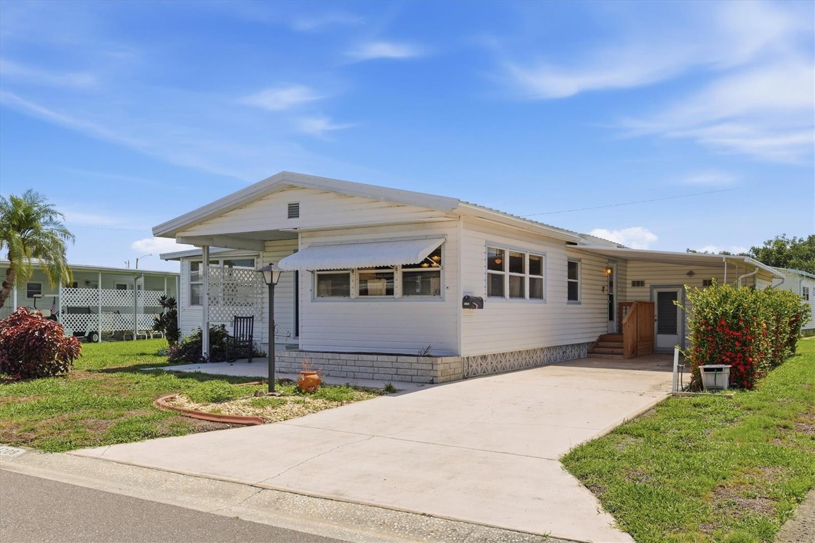 Welcome to Tidevue Estates, a friendly and active 55+ community where you own the land—no lot rent! This light-filled, move-in-ready home is being offered turn-key furnished, making it easy to start enjoying the Florida lifestyle from day one. A welcoming front porch opens into a bright Florida room, providing valuable extra living space that's perfect for a home office, reading nook, and a sofa sleeper for overnight guests. Neutral white oak laminate flooring and updated windows create a fresh, airy feel throughout the home. The spacious dining room flows seamlessly into the kitchen, where a center island offers additional prep space and the perfect gathering spot for family and friends. Just beyond, the cozy living room provides a comfortable place to relax. The split-bedroom floor plan offers privacy for you and your guests. The guest bedroom features a convenient Murphy bed, maximizing flexibility when the room isn't in use. Outdoor living is just as inviting. Transform the covered carport into your own outdoor living room—ideal for entertaining, dining, or simply enjoying Florida's beautiful weather. The extra-large shed is a standout feature, offering a workshop, dedicated art or craft room, and plenty of storage space. Low HOA of only $600 annually. Pets are not permitted. Plenty of activities to keep you busy in this community. Updated fitness center. Meet friends and make new ones for a game of indoor pickleball, bocce ball, or shuffleboard. Join the Golf League. Take a bike or golf cart ride to Veterans Park or Kays Park to watch the wildlife and enjoy the sunset. Ellenton Premium Outlet Mall, restaurants, and medical facilities are just minutes away. Easy access to I-75 to explore Sarasota. Not to mention a short drive to our beautiful Gulf Beaches. Whether you're looking for a seasonal retreat or a year-round residence, this beautifully maintained home offers comfort, versatility, and a wonderful lifestyle in Tidevue Estates.