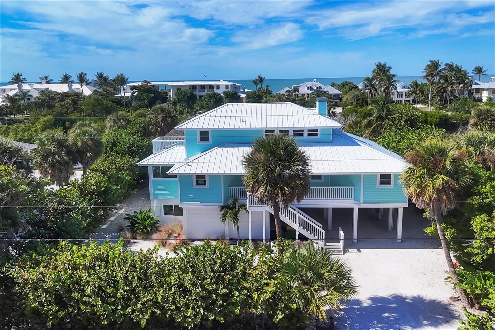 SIGNIFICANT PRICE REDUCTION — DEEDED BEACH ACCESS — Attractively priced 3-bedroom, 2-bath home offering easy island living with strong value. Sold turnkey furnished (inventory available), this property is move-in or rental ready.

The open floor plan features high ceilings, great natural light, and a spacious living area with a wood-burning fireplace. A bright sunroom provides flexible space, and the separate dining area flows well for everyday use or entertaining.

The kitchen includes new appliances, highlighted by a Wolf dual fuel gas range with griddle, plus ample cabinet and counter space. Additional updates include newer AC and impact-rated hurricane doors and windows.

Outdoor features include a large Timberline deck, heated pool and spa (resurfaced in 2023), new pool pump and heater, and an authentic chickee hut for outdoor living. A 2023 metal roof adds long-term value.

Strong rental history adds to the appeal.

Boat Slip #5 at Boca Grande North is available separately, featuring a 10,000 lb lift with a new motor (MLS ID #D6143184).

A well-maintained property with deeded beach access and a recent price improvement—ready for immediate enjoyment or income.