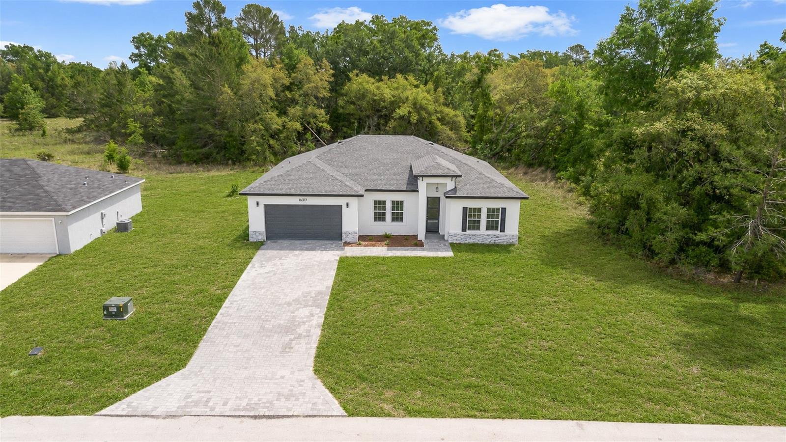 This stunning home, located on a spacious lot has 4 bedrooms and 2 bathrooms, large living room with open concept kitchen, equipped with stainless steel appliances including a range, refrigerator, garbage disposal, dishwasher, and microwave, as well as an island and ample cabinet space, perfect for hosting large family gatherings. Rooms are spacious and comfortable, which allows for seamless flow and natural light throughout the home. The house has several upgrades, such as vinyl flooring, floor to ceilings tiles on bathrooms and lanai with space for outdoor kitchen. With a two-car garage, in addition to being more spacious, has a greater height than standard. It is a perfect place to live or invest. Closing costs available.