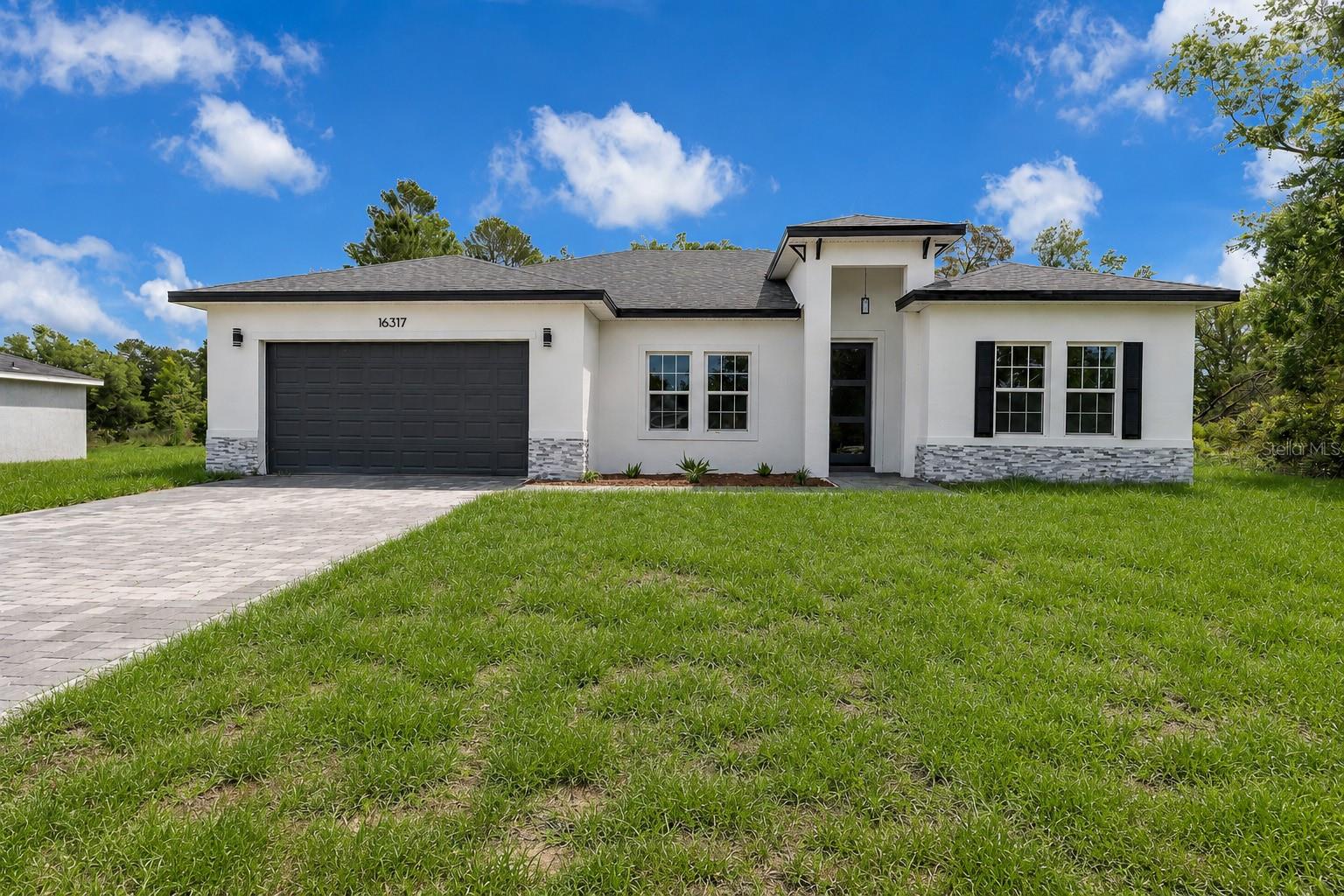 This stunning home, located on a spacious lot has 4 bedrooms and 2 bathrooms, large living room with open concept kitchen, equipped with stainless steel appliances including a range, refrigerator, garbage disposal, dishwasher, and microwave, as well as an island and ample cabinet space, perfect for hosting large family gatherings. Rooms are spacious and comfortable, which allows for seamless flow and natural light throughout the home. The house has several upgrades, such as vinyl flooring, floor to ceilings tiles on bathrooms and lanai with space for outdoor kitchen. With a two-car garage, in addition to being more spacious, has a greater height than standard. It is a perfect place to live or invest. Closing costs available.