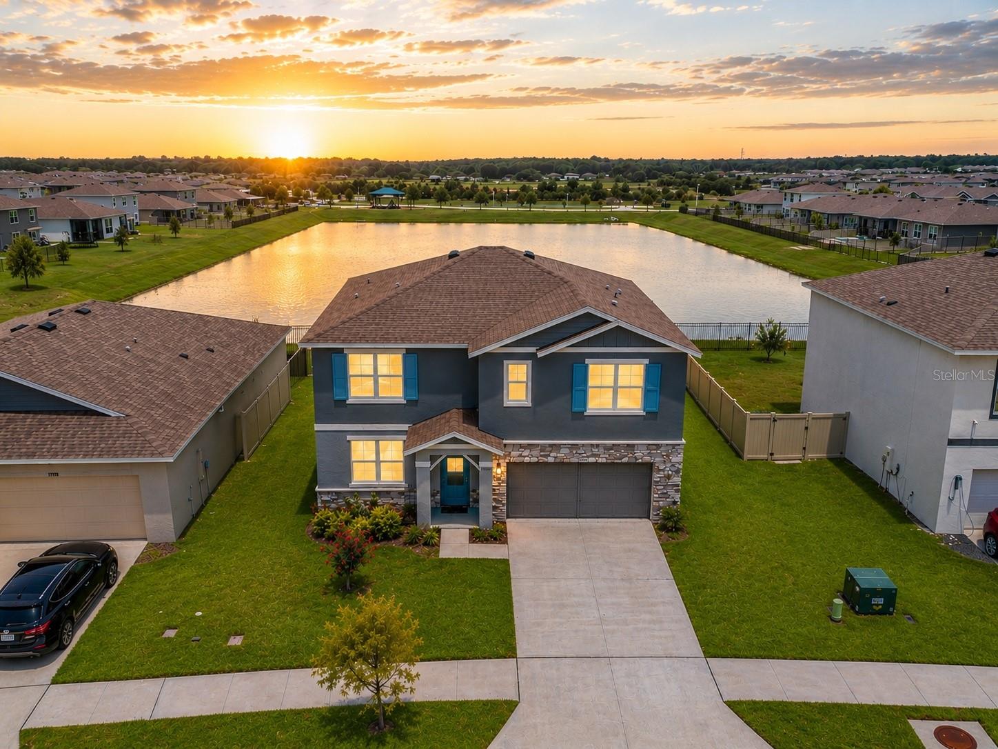 Why wait six to ten months on a new build when the upgrades are already done? This nearly-new 2023 home delivers 5 bedrooms, 3 full baths, and 2,605 sq ft of move-in-ready space on a quiet pond-view lot in the heart of Epperson Lagoon in Wesley Chapel. An open great room flows to a kitchen finished with quartz counters, designer tile backsplash, flat-panel cabinetry, and a stainless appliance package — everything buyers add at extra cost in new construction, already here. Luxury vinyl runs through the main living, with quartz in all three baths. A first-floor bedroom and full bath make an ideal guest space or home office; upstairs offers a spacious owner's suite with walk-in closet, a versatile loft, and additional bedrooms. Built for Florida with all-block construction, storm-rated windows and doors, a smart-home package, and energy-efficient HVAC. The covered patio overlooks an expansive backyard space with no rear neighbors...And that VIEW!  This is lifestyle living: ownership unlocks the nation's first Crystal Lagoon — beach, swim-up bar, water slide, and summer events — in a golf-cart-friendly community with parks and trails. Publix, Starbucks, dining, and top-rated schools are minutes away, with quick I-75 access to Wiregrass, Tampa Premium Outlets, and downtown Tampa. Same lagoon, same finishes, none of the wait.  Reach out today!! **Ask us about our Preferred Lender Incentive available where you could save thousands $$$**