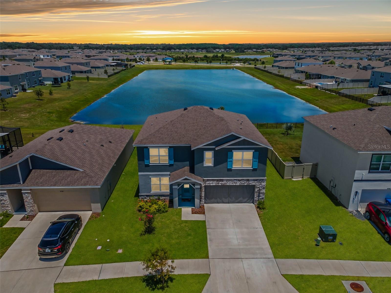 Why wait six to ten months on a new build when the upgrades are already done? This nearly-new 2023 home delivers 5 bedrooms, 3 full baths, and 2,605 sq ft of move-in-ready space on a quiet pond-view lot in the heart of Epperson Lagoon in Wesley Chapel. An open great room flows to a kitchen finished with quartz counters, designer tile backsplash, flat-panel cabinetry, and a stainless appliance package — everything buyers add at extra cost in new construction, already here. Luxury vinyl runs through the main living, with quartz in all three baths. A first-floor bedroom and full bath make an ideal guest space or home office; upstairs offers a spacious owner's suite with walk-in closet, a versatile loft, and additional bedrooms. Built for Florida with all-block construction, storm-rated windows and doors, a smart-home package, and energy-efficient HVAC. The covered patio overlooks an expansive backyard space with no rear neighbors...And that VIEW!  This is lifestyle living: ownership unlocks the nation's first Crystal Lagoon — beach, swim-up bar, water slide, and summer events — in a golf-cart-friendly community with parks and trails. Publix, Starbucks, dining, and top-rated schools are minutes away, with quick I-75 access to Wiregrass, Tampa Premium Outlets, and downtown Tampa. Same lagoon, same finishes, none of the wait.  Reach out today!! **Ask us about our Preferred Lender Incentive available where you could save thousands $$$**
