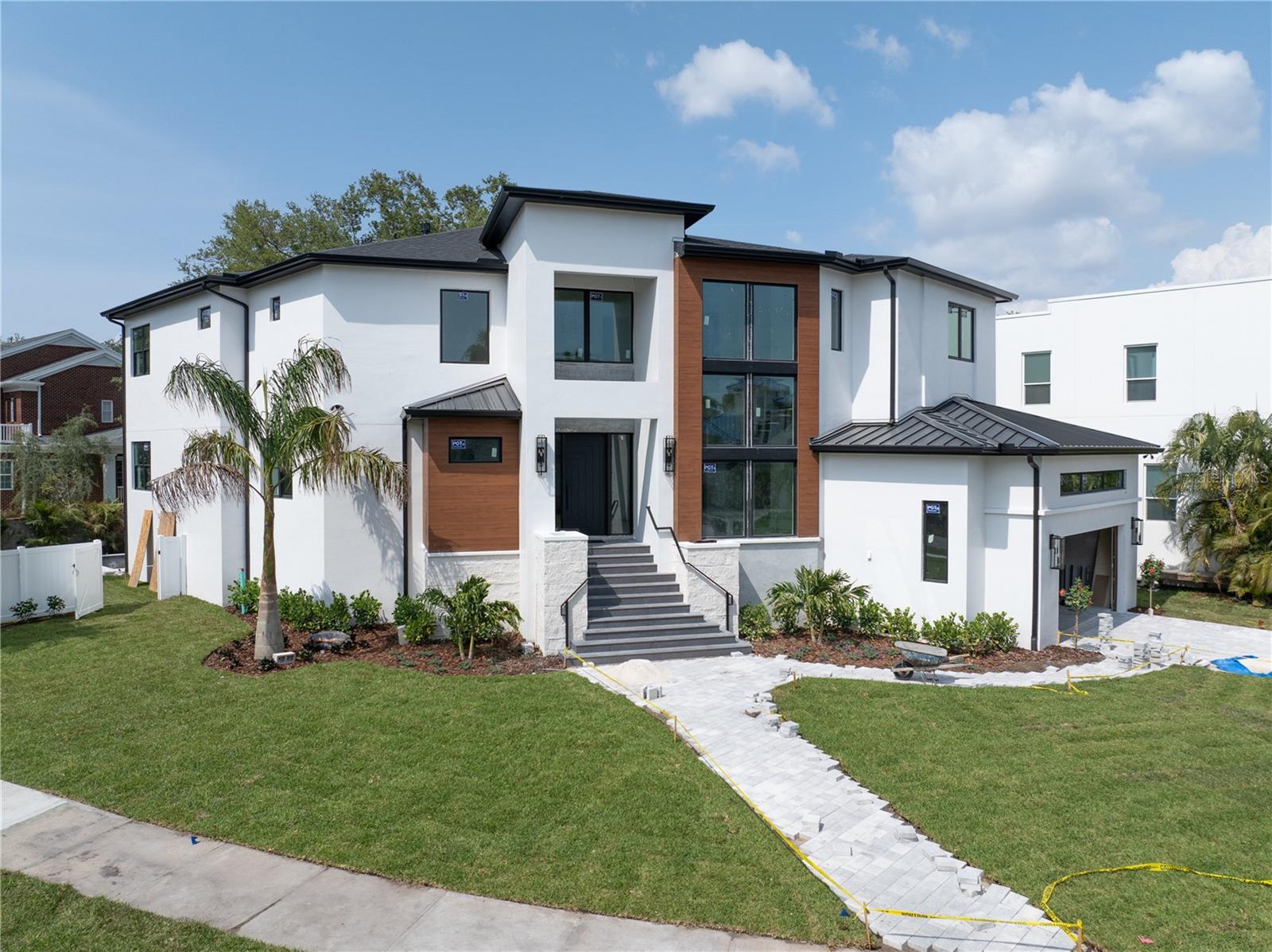 Under Construction. Projected completion April 2025. **Stunning New Construction Home built by Fein Custom Homes in South Tampa**
Welcome to your dream home! This exquisite 5-bedroom, 5.5-bath residence boasts an impressive 5,645 square feet of luxurious living space, situated on a sprawling 0.3-acre oversized lot in the heart of South Tampa. As one of Tampa's most respected and premier builders, Fein Custom Homes has crafted a masterpiece that will exceed your expectations.
Step inside to discover an incredible kitchen that is truly the heart of the home. It features integrated fixed windows, custom white oak cabinetry, and premium appliances, including a 48-inch Wolfe gas range and a 48-inch Sub Zero column refrigerator and freezer, with white oak panel doors. An inviting dining area off the kitchen is perfect for casual dining, while the butler’s pantry/walk-in pantry, equipped with custom wood cabinets, wine fridge, an ice machine, and an integrated in-wall water dispenser, offers ample space and convenience with direct access from the oversized 2.5-car garage for ease with loading and unloading groceries!
The kitchen seamlessly opens into the main great room, where glass sliding doors lead to a spectacular lanai and outdoor kitchen overlooking an inviting Pool with a sun deck and heated spa.  Enjoy outdoor entertaining with a sink, grill, and unique features like a pre-plumbed dog wash and outdoor shower, making this space ideal for both relaxation and hosting.
The focal point of this home Is a stunning, custom, floating double steel stringer staircase. It features open risers and elegant white oak treads that merge modern design with warmth. This staircase serves as a striking centerpiece that showcases exceptional craftsmanship while seamlessly blending style with functionality.
Retreat to the primary suite, a true sanctuary with unique wall and ceiling finishes that extend into the luxurious primary bath.
Indulge in premium Brizo fixtures, a stunning
soaking tub, a built-in makeup vanity, and an oversized shower featuring dual showerheads, a handheld option, and a ceiling-mounted rain head. This suite is also pre-wired for a serum refrigerator and makeup mirror, ensuring every detail has been thoughtfully considered. Each secondary bedroom comes with its own private bathroom and spacious walk-in closet, providing comfort and privacy for family and guests alike. This home is a testament to amazing design and timeless elegance, with meticulous attention to detail that surpasses anything you've seen before. The potential for an elevator, offers convenience and accessibility for all generations. There is even room to build a pickleball court making this property perfect for both relaxation and recreation.. Don't miss the opportunity to own this stunning new construction gem in South Tampa-your oasis awaits!