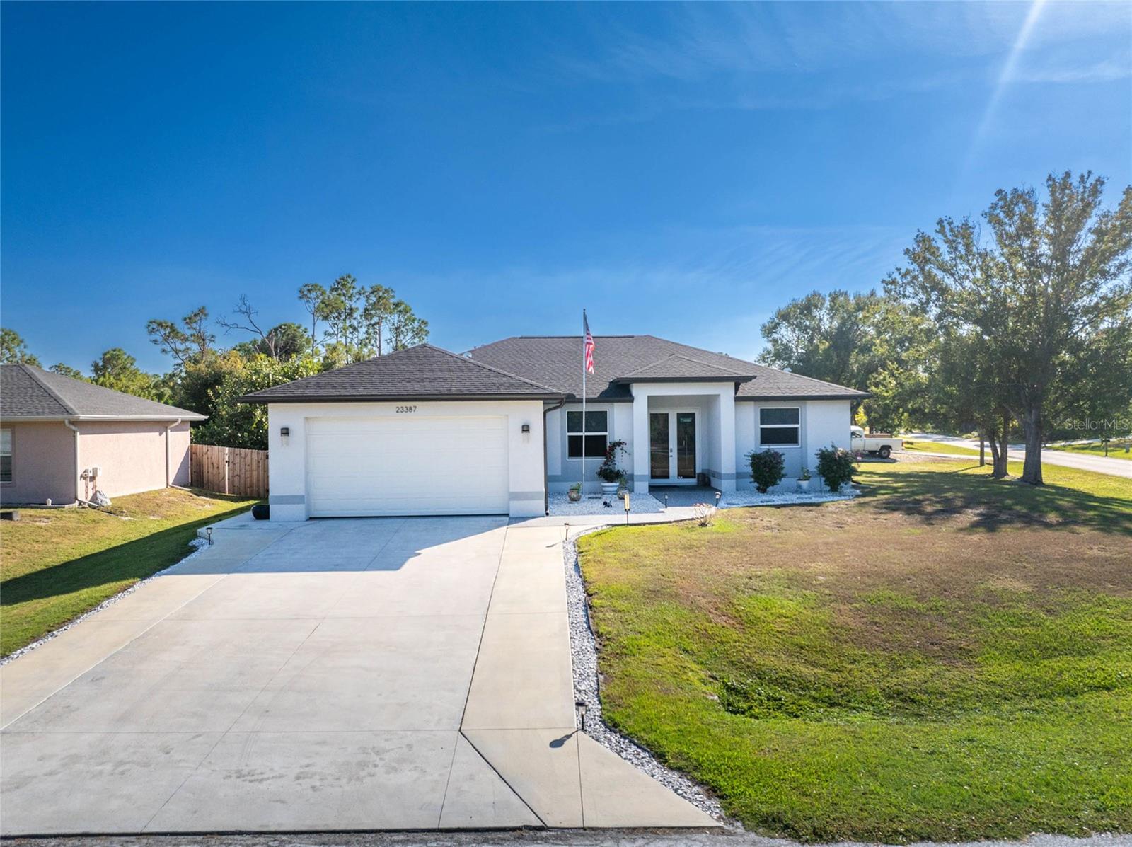 MOVE-IN READY 2022 HOME IN PUNTA GORDA, FL – 3BR/2BA WITH PREMIUM UPGRADES. Discover your perfect Florida retreat in this impeccably maintained 3-bedroom, 2-bathroom home offering 1,618 square feet of comfortable living space. Built in 2022, this lovely home is like new, is set on an extra-large lot, and features many premium upgrades. The open-concept floor plan with 9-foot ceilings provides an expansive feel and plenty of natural light, creating a welcoming atmosphere. The great room and all bedrooms have ceiling fans installed, there’s gorgeous custom lighting in the foyer, dining room, and kitchen. Show stopping designer accent walls are in the great room and dining room. Scratch- and water-resistant vinyl flooring throughout the home provides a seamless and low-maintenance look. Impact windows and doors, a water softener, in-ground termite protection, and an epoxy garage floor with a lifetime warranty will give you peace of mind and protection. Additionally, the X flood zone location provides savings on insurance. The spacious great room features a tray ceiling, designer accent wall, and a slider that opens to the screened lanai—perfect for enjoying Florida's coastal lifestyle. Just imagine the coastal breezes you'll enjoy while friends in the north are freezing. The modern kitchen will truly be the heart of the home. Spacious quartz counters, tile backsplash, real wood soft-close cabinets, pantry, and a center island with breakfast bar will make mealtime and entertaining easy. The primary suite features access to the lanai, dual closets, an en suite with dual vanities, a walk-in shower, and soaking tub. The two additional bedrooms share a guest bath with the vanity separated from the tub/shower combo and water closet by a pocket door for privacy. The guest bath also has an exterior door direct to the lanai for a future pool (there is room for a pool in the backyard). Step outside to a nicely landscaped yard, fenced backyard, large, screened lanai for outdoor living, and a 10’ x 20’ shed for storage needs. The location offers convenient access to everything you need. Daily errands become a breeze with grocery stores, pharmacies, numerous restaurants, and Sunseeker Resort within a ten-minute drive. Families will appreciate the proximity to highly-rated Charlotte County schools, making school commutes manageable and stress-free. Communing is made easier with access to I-75 in less than 10 minutes and Highway 41 is even less. All that, AND there are NO DEED RESTRICTIONS OR CDD FEES. This is your chance for a like-new home in a prime location with window treatments, ceiling fans, rain gutters, and upgrades already completed. Some furnishings are available via an additional bill of sale. This is a must-see home. It checks all the boxes - beautiful, great location, quality, well-maintained, and designer touches!