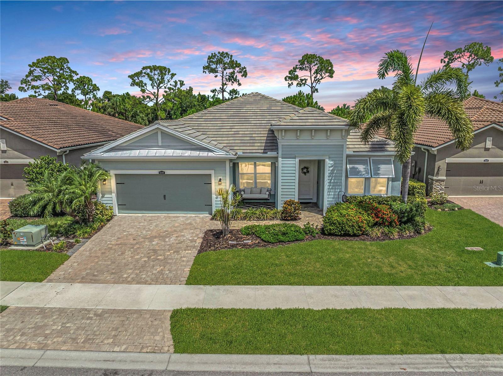 Some homes impress with beautiful finishes. Others leave a lasting impression because of how they make you feel. This home in Renaissance at Wellen Park delivers both. Tucked near the end of a quiet street, with one of Wellen Park's scenic trail systems just moments away, the setting feels peaceful and private, yet you're only a short stroll from the resort-style pool, clubhouse, fitness center, tennis and pickleball courts. It's the kind of location that makes every day feel just a little more relaxed. From the moment you step through the impact-rated front door, the home feels light, airy, and welcoming. High ceilings, eight-foot interior doors, engineered hardwood flooring, and a beautifully crafted tongue-and-groove tray ceiling create a light-filled interior where timeless architectural details and a refined, designer-inspired aesthetic come together effortlessly. Thoughtful sightlines carry your eye from the entry through the great room and out to the lanai, creating an open, connected flow that feels both elegant and inviting. Designed for connection, the kitchen naturally becomes the heart of the home. Anchored by an oversized quartz island with abundant seating, generous prep space, and plentiful cabinetry, it's designed for everything from casual breakfasts to holiday entertaining. The open connection to the dining area and great room keeps everyone together, while expansive sliding glass doors create a seamless connection to the spacious screened and tiled lanai. Beyond, the tree-lined backyard provides a peaceful backdrop where morning coffee, weekend gatherings, or quiet evenings all feel right at home. The layout is every bit as thoughtful as the finishes. The primary suite provides a peaceful retreat, while a private guest suite tucked behind a pocket door features its own en suite bath, creating the perfect space for family or overnight guests. A third bedroom provides comfortable accommodations, while a separate flex room enclosed by French doors adds exceptional versatility, making it equally suited as a home office, library, media room, or creative retreat. Thoughtfully placed linen closets and generous storage throughout the home add convenience without sacrificing style. The spacious laundry room is as functional as it is convenient, featuring built-in cabinetry, a utility sink, additional storage, and direct access from the primary suite, making everyday routines just a little easier. Life in Renaissance extends well beyond your front door. Residents enjoy a beautifully appointed clubhouse, resort-style pool, fitness center, tennis and pickleball courts, playground, and a full calendar of community events, all while benefiting from one of Wellen Park's most value-driven HOA offerings. Sidewalk-lined streets encourage morning walks and evening strolls, while nearby scenic trails provide easy access to one of Wellen Park's community parks and dog park. Combined with the home's easy walk to the neighborhood amenities, it's a lifestyle that's as convenient as it is enjoyable. Located just minutes from Downtown Wellen Park, CoolToday Park, shopping, dining, and Gulf beaches, this home offers more than beautiful finishes. It offers a lifestyle where everyday moments feel a little more connected, a little more convenient, and a little more relaxed. ¤ Please see 3D Tour and Video ¤