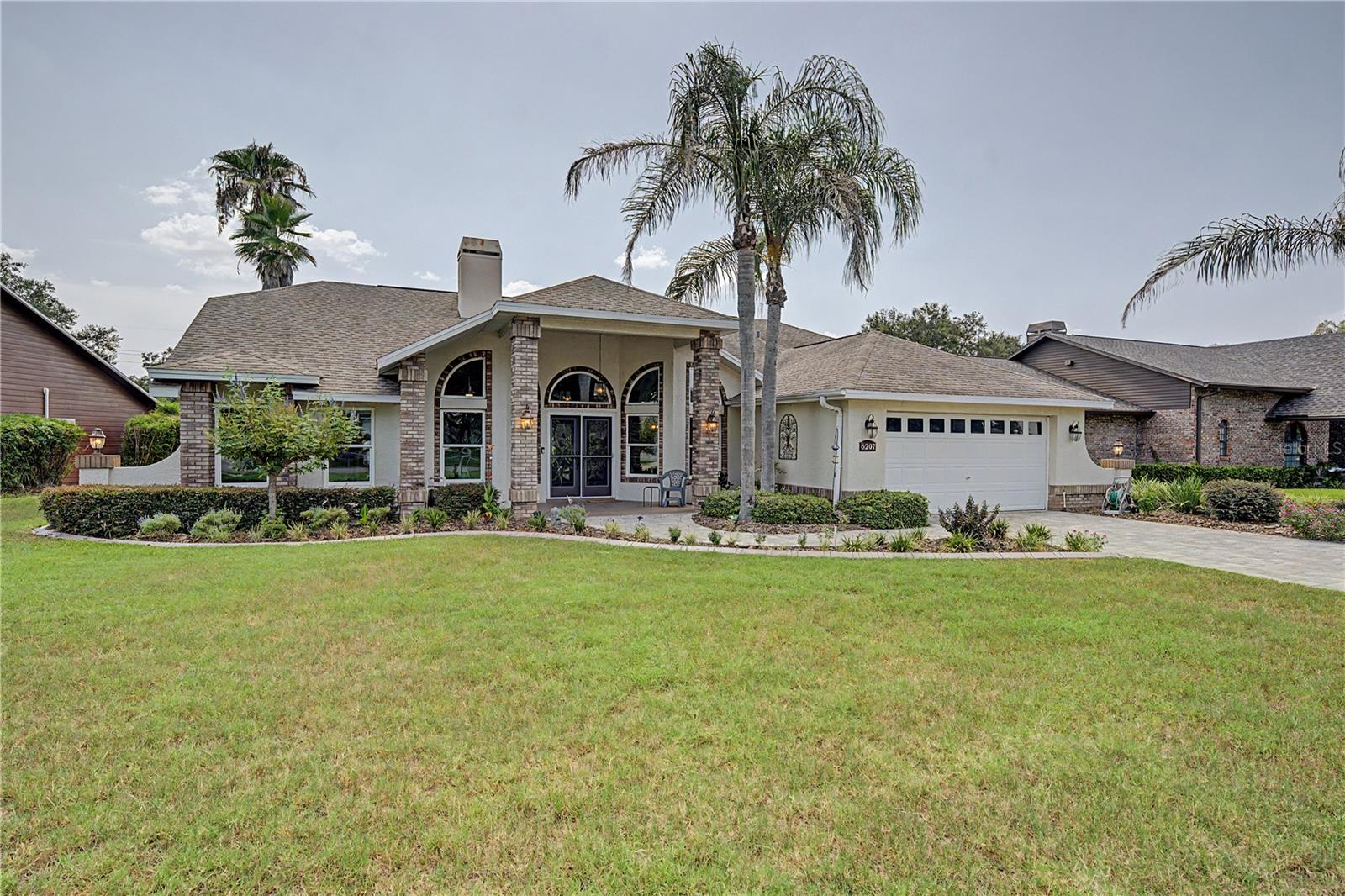 Welcome to one of the finest values in the established Silver Oaks community of Zephyrhills! Situated on a premium pond homesite with picturesque POND views, this exceptional custom-built Bluestone home offers over $85,000 in recent renovations and upgrades, combining timeless quality with today's modern finishes. Nestled on a quiet street with gated access at the rear of the community, you'll appreciate the peaceful setting with no through traffic while remaining just minutes from shopping, dining, healthcare, recreation, and everything the growing Zephyrhills and Wesley Chapel areas have to offer. From the moment you arrive, the home's outstanding curb appeal is evident with fresh landscaping, $7,000 in new sod, decorative concrete landscape borders, and elegant leaded glass double entry doors. Inside, soaring vaulted ceilings, skylights, lighted plant shelves, and an abundance of natural light create an open, bright, and welcoming atmosphere. The thoughtfully designed floor plan features formal living and dining rooms off the foyer with a spacious transition into the spacious Great Room, highlighted by a gas fireplace and expansive views of the Florida room with tranquil pond views beyond. The enclosed 300-square-foot Florida room with sliding windows provides the perfect year-round space to relax, entertain, or simply enjoy the natural scenery and SPECTACULAR SUNSETS! The heart of the home is the stunning 2025 fully remodeled kitchen, showcasing beautiful white cabinets, gleaming granite countertops, 2025 stainless steel appliances, beveled edge subway tile backsplash and stylish finishes that make both everyday living and entertaining a pleasure. Additional 2025 improvements include fresh interior paint throughout, new 5¼-inch baseboards, updated lighting, and gorgeous luxury vinyl plank flooring that continues throughout the home. The spacious primary suite offers a peaceful retreat with generous closet space and a private en-suite bath, while two additional bedrooms and a second full bathroom provide comfortable accommodations for family, guests, or a home office. Practical upgrades include a 2018 roof, updated windows, a high-efficiency 4-ton Trane air conditioning system with water heater recycling technology, an electric vehicle charging station, golf ball protection screens on three windows, and a paver patio complete with a firepit for enjoying Florida's beautiful evenings outdoors. Silver Oaks is one of East Pasco's most established communities, known for its mature oak trees, winding streets, scenic ponds, and welcoming atmosphere. Residents enjoy a low HOA, no CDD fees, and convenient access to the YMCA, golf courses, restaurants, shopping, movie theaters, medical facilities, and the popular Metro Crystal Lagoons. Easy access to major highways for easy commute to Wesley Chapel, Tampa, Lakeland, Orlando, Ocala, the International airports and Famous Florida beaches!  If you've been searching for a move-in ready home with quality construction, breathtaking views, exceptional updates, and an unbeatable location, this beautifully renovated home delivers it all.  Schedule your private showing today and discover why this IS a great place to call HOME!