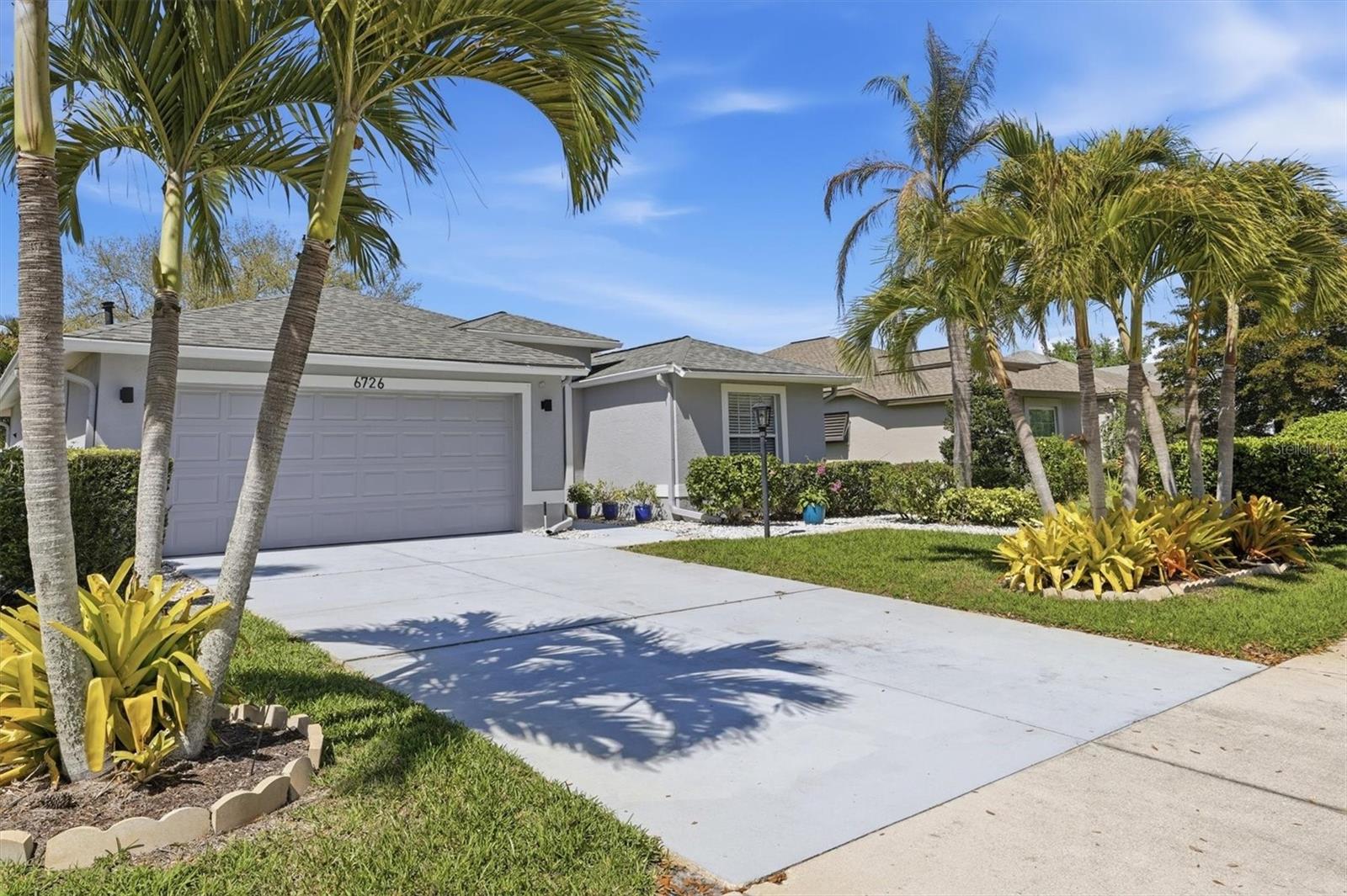 Welcome to Carlyle at the Villages of Palm Aire, a sought-after community known for its convenient location and beautiful surroundings. 
This well-maintained home offers 3 bedrooms, 2 bathrooms, plus a unique office space located within the primary suite, thoughtfully separated from the bedroom area by a wall to create a private workspace. Enjoy relaxing on the lanai overlooking the fully fenced backyard, perfect for pets or entertaining. The 2-car garage features AC and insulation, making it ideal for a workshop, gym, or additional storage. Major updates include a roof replaced 3 years ago and an AC system just 1.5 years old. The home also includes a sprinkler system keeping the lawn looking its best. Conveniently located just minutes from University Town Center, offering a wide variety of shopping, dining, and entertainment options.