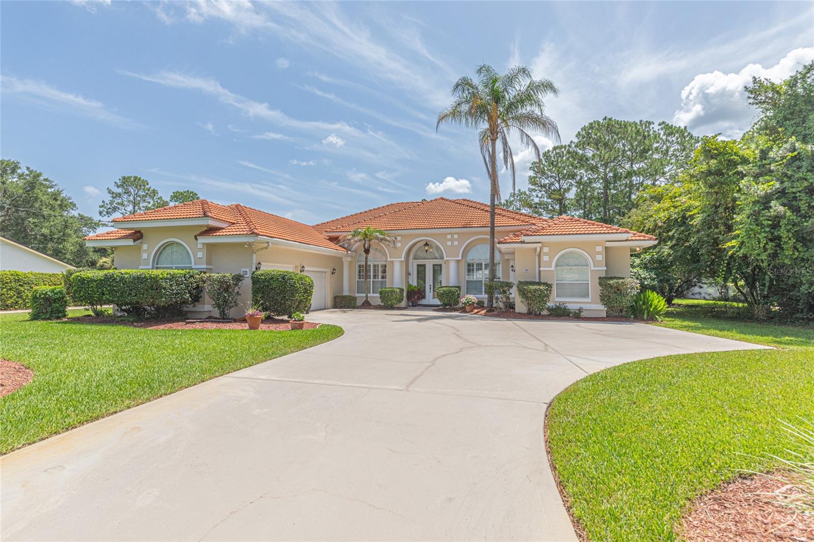 Welcome to this exceptional one-owner home in the highly sought-after Pine Lakes community, just minutes from The Pine Lakes Signature Golf Course by Arnold Palmer. From the moment you arrive, the extended, oversized driveway and beautifully maintained grounds reflect the pride of ownership found throughout this remarkable property. Situated on an oversized lot with 100 feet of freshwater canal frontage, this spacious home offers four bedrooms or three bedrooms plus a dedicated office, along with three full bathrooms, abundant storage, and the added peace of mind of a whole-house Generac generator. Step through the elegant etched-glass front entry door and be immediately captivated by the breathtaking views of the sparkling pool and tranquil backyard beyond. Thoughtfully designed with a split-bedroom floor plan, this home provides exceptional privacy for both family and guests. The beautifully renovated kitchen features 42-inch KraftMaid cabinetry, granite countertops, a built-in computer desk with filing cabinet, and an open layout that flows seamlessly into the inviting family room. Relax by the gas fireplace, enjoy the elegance of plantation shutters, or gather in the sunny breakfast nook, where a stunning mitered window frames picturesque views of the expansive screened pool and waterfall oasis. Escape to your private owner's suite after a long day and unwind while enjoying peaceful views of the sparkling pool, with direct access to the lanai through sliding glass doors. The spacious suite offers a tranquil retreat, complemented by an en-suite bathroom designed for comfort and convenience, creating the perfect place to relax and recharge. This exceptional home offers the perfect blend of comfort, elegance, and Florida lifestyle. From the stunning waterfall pool and peaceful freshwater canal setting to the thoughtfully designed interior and quality upgrades throughout, every detail has been meticulously maintained. Don't miss this rare opportunity to own a beautiful home in one of Palm Coast’s most desirable neighborhoods and start living the Florida dream.