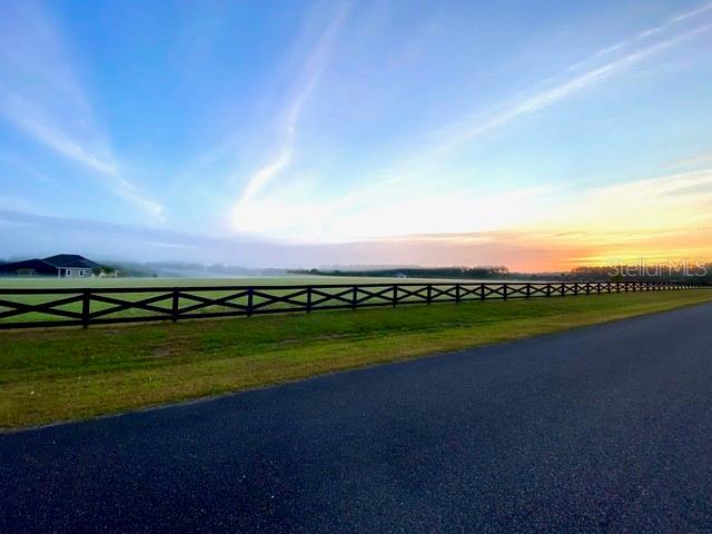 OPEN BUILDER! 5 ACRES! Discover the perfect setting to build your dream home on this stunning five-acre lot in the gated Charleston neighborhood. Ideally located just north of NW 39th Avenue near CR 241, this exceptional community offers a peaceful, private atmosphere while remaining close to everyday conveniences. As you enter Charleston, a gently winding road lined with majestic oak trees welcomes you home. A coded gate provides access to an exclusive cul-de-sac of only 12 homes, each situated on five acres—creating a rare blend of space, privacy, and community. Enjoy quick access to Publix, Walgreens, shopping, dining, and I-75. Horses are welcome, with nearby riding trails connecting to the neighboring Grove community. Choose your own builder and bring your vision to life in one of Gainesville’s most sought-after settings. HOA includes Cox fiber-optic high-speed internet and over 200 cable channels.