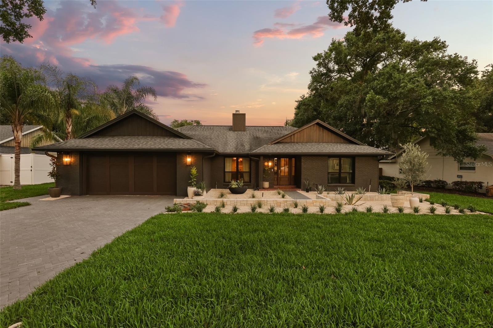 Ideally in one of Maitland’s desired neighborhoods, Versailles, this fully renovated home blends timeless architecture with modern comfort. With sun-filled interiors, an open-concept layout, a serene primary suite and freshly landscaped grounds, every detail supports effortless living. This three-bed, two-bath home stretches over 2,151 square feet and is situated on 0.29 of an acre. This classic ranch style offers a split bedroom plan with endless function. A gracious foyer welcomes you into this serene space with blonde oak flooring, limewash accent walls, a vaulted ceiling with wood beam accents, fresh neutral tones, designer fixtures and ambient lighting that softens the spaces. This home features formal dining and a flex space that could be a fourth bedroom or office, offering many layout choices. The combined kitchen and living room showcases a wood-burning fireplace with a fluted marble surround as the focal point. The kitchen combines crisp, clean-lined cabinets and warm-wood-toned floor-to-ceiling storage cabinets finished with brushed-gold hardware. A waterfall center island with quartz counters that continue up the backsplash for a stylish design. Clear view sliders open to a covered porch with a tongue and groove ceiling feature and is part of a screened pool, making entertaining a breeze. Recently installed turf grass for ease of maintenance and keeps it all looking very fresh. The pool was recently refinished and a side-yard sauna rounds out this oasis. The primary suite is a private retreat with an oversized walk-in shower with beautiful vertical Zellige tile. Dual vanities with custom arched mirrors, sconce lighting and porcelain-marble floors add to the space. Built-in linen closets and dual bedroom closets make organization simple. Additional highlights include both baths completely renovated, new kitchen appliances (LG/GE stainless steel) induction range, new interior doors and hardware, new ceiling fans, new Pella front doors and Impervia slider doors across the back of the home, new Pella front windows, a new Hass garage door (2025), the whole yard professionally designed and landscaped (2026), a sauna (2024), a roof (approximately 2018) and a water heater (2023). This neighborhood enjoys a community lake lot with access to Lake Minnehaha, part of the Winter Park lake chain. Strategic location close to major roadways, short distance to the Sunrail and close to all amenities that make Maitland special. Zoned for some of the best Orange County schools: Lake Sybelia, Maitland Middle and Winter Park High, a nationally renowned school for its International Baccalaureate Program.