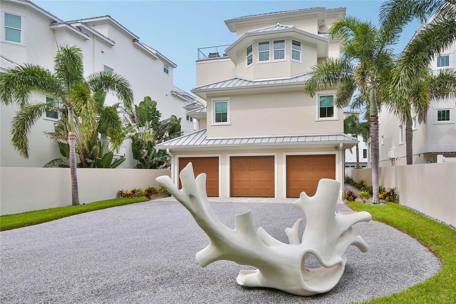Motivated sellers! In fact, they are moving right next door! The sellers are nearing completion of their new home, which was deliberately designed and positioned to preserve the breathtaking Gulf views of this beachfront retreat. Feel the captivating energy of this home from the moment you enter the private gate to the meticulously landscaped grounds, including an award-winning heated saltwater pool with spa jets, a sun shelf, and custom-designed waterfall. Mornings begin with a soft breeze from the Gulf as you take in the magical sunrise from your 4th-floor deck. Retreat at the day’s end to your 3rd-floor lanai to relieve all the day's stresses. You have a front row seat nightly for nature’s most spectacular show. North Shell Road is the ultimate destination to witness Siesta Key’s most enchanting sunsets, where the sky ignites in hues of gold and crimson over Lido Key. The Gulf’s shimmering waters stretch endlessly before you, bathed in the warm glow of dusk, transforming your private retreat into a masterpiece of light and color. The panoramic views from this prestigious North Siesta Key home are simply magnificent. This home charms with its bold contemporary lines and warm, seamless connection to its pristine surroundings. The sophisticated design blends easily with the warmth and energy of the natural light that flows throughout. Quartz, concrete, soapstone, and live-edge designs blend with soft bamboo floors. This one-of-a-kind sanctuary boasts every upgrade you can imagine. 3916 North Shell Road is where ultimate luxury intersects with coastal splendor. ***Private showings for discerning buyers are available by appointment. Sellers respectfully request that potential buyers wear the shoe booties provided for showings.