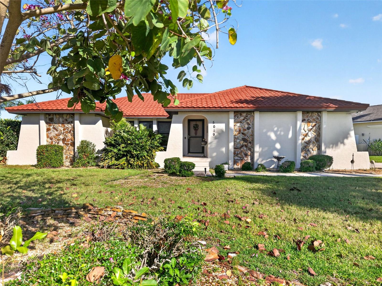 Experience the ultimate Florida lifestyle in this beautifully maintained 3-bedroom, 2-bath waterfront pool home, perfectly situated on a premium approx. 1/2-acre corner lot in the highly desirable golf and boating community of Burnt Store Isles. A boater's dream, the property showcases architectural flair with its custom stone accent panels and sits on a large, deep-water turning basin with seamless sailboat access to Charlotte Harbor and the Gulf. Enjoy sweeping wide-basin views and enviable northwestern exposure for unforgettable nightly sunsets.

Step through the welcoming foyer into an inviting, sun-drenched open floor plan highlighted by soaring cathedral ceilings, easy care tile flooring in the main living areas and expansive windows giving the home an abundance of natural light. A custom built-in media and display wall anchors the main living area, which features a brand-new sliding glass door (installed 2025) opening directly to the outdoor oasis. Designed for effortless indoor-outdoor living, nearly every room transitions smoothly to the lanai. The kitchen serves as the heart of the home, complete with beautiful solid oak cabinetry, solid surface countertops, a built-in desk, and a convenient breakfast bar. A thoughtful split floor plan ensures maximum privacy for guests, complete with an adjacent pool bath, while the primary suite offers a true retreat featuring direct lanai access and a beautifully redesigned ensuite with dual sinks and a custom-tiled glass shower.

Step outside to your private paradise, where a covered lanai and a screened pool with a new cage overlook the spacious backyard and city-maintained seawall. This property offers total peace of mind with significant recent updates, including a new metal roof, high-impact windows, storm covers, and a new A/C system from 2024. Located just minutes from Twin Isles Country Club and a short drive to the Punta Gorda Yacht Club, historic downtown, Fishermen's Village, and I-75, this exceptional property blends premium waterfront living with unparalleled convenience. **Barge in photos is necessary as the city is currently replacing the seawall.