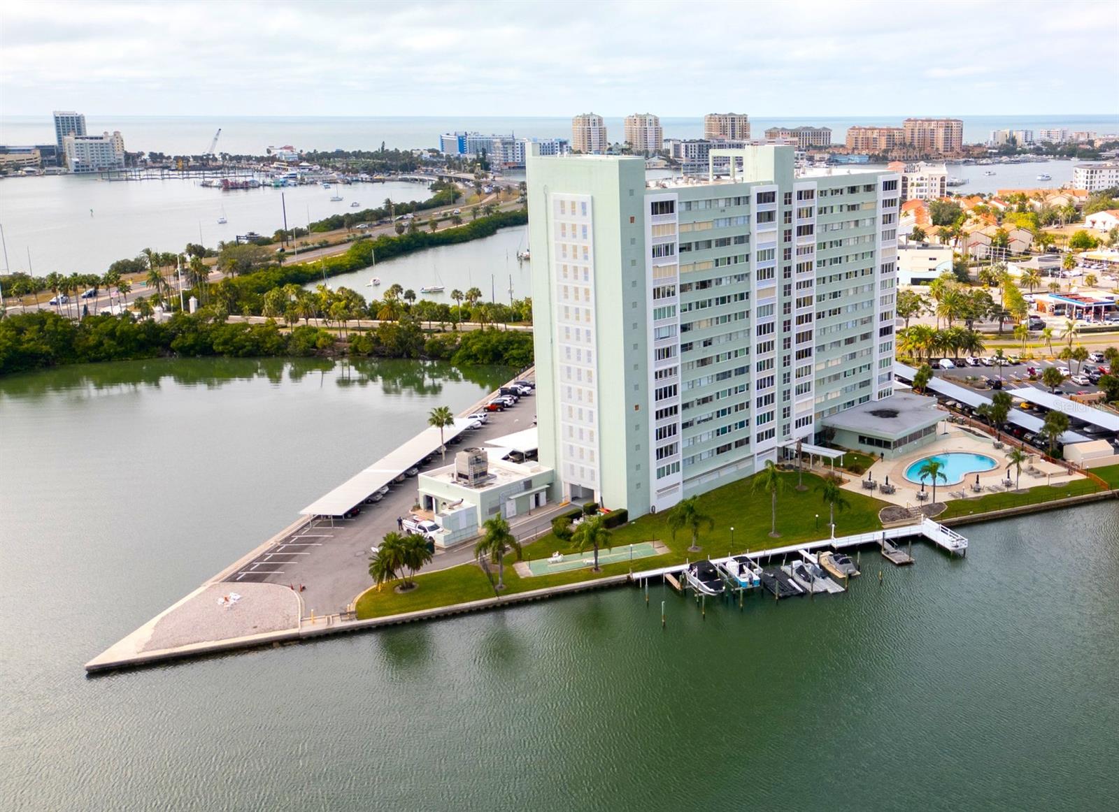 This stunning two-bedroom, one-bathroom condo with breathtaking views is ready for you to call it home. Completely renovated from top to bottom with waterproof luxury laminate flooring, fresh new paint, new impact resistant sliding doors and windows, gorgeous kitchen with solid wood cabinets and granite countertops, new lighting, and a bathroom that feels like a spa! Upon entering the condo, you will be captivated by the stunning vistas of Clearwater Beach and the Intracoastal waters, facing west. At Horizon House, you are invited to explore an array of high-end amenities including a year-round heated pool, a dock with first-come boat slips, a fully equipped fitness center, a recreation room, and a library. The building obtains a powerful generator, and also a car wash service! Additionally, each floor features a no-charge laundry room for residents' convenience. Living at Horizon House, means embracing a lifestyle where nearly everything is taken care of for you. All you need to do is enjoy life! Picture yourself spending leisurely days by the pool, soaking up the sun, or walking along the pristine white sands of Clearwater Beach. In addition to the beach, you'll find a variety of restaurants, shops, galleries, and the renowned Clearwater Aquarium nearby. Whether you prefer the tranquility of a peaceful retreat or the lively atmosphere of a bustling beach town, this condo, the Horizon House and it's location offers the best of both worlds. Clearwater Beach is a world known destination that attracts millions of tourists each year, yet it remains a serene haven for its residents. Call for a showing today!