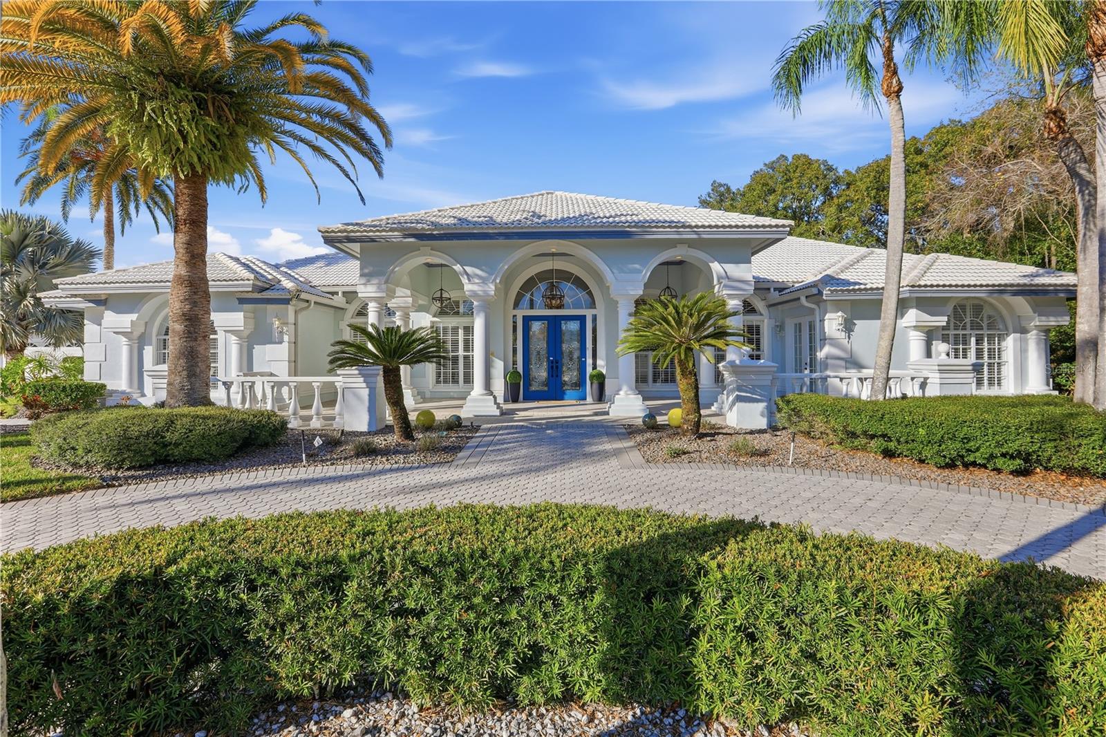 Set behind the exclusive double gates of Crescent Oaks, this extraordinary custom estate is situated on an impressive 2.83-acre homesite, offering sweeping golf course vistas, tranquil conservation views, and an unparalleled sense of privacy in the coveted East Lake corridor.
Originally built by a former president of Arthur Rutenberg Homes, the residence spans approximately 5,800 square feet of thoughtfully designed single-story living where timeless architecture meets refined luxury. Soaring 12-foot ceilings, coffered details, extensive crown molding, transom windows, designer lighting, and walls of French doors create an elegant yet inviting atmosphere throughout.
Designed for both grand entertaining and everyday comfort, the chef’s kitchen serves as the centerpiece of the home with premium appliances, custom cabinetry with pull-out storage, center island, breakfast bar, built-in buffet, and an adjoining wet bar with wine cooler. The kitchen flows seamlessly into expansive living and gathering spaces accented by custom built-ins, a dramatic stone feature wall, and sweeping outdoor views.

The luxurious primary suite offers a private retreat with a spa-inspired bath featuring marble finishes, a freestanding soaking tub, oversized walk-in closet, dedicated hot water tank, and private safe. A separate-entry guest or in-law suite with its own sitting room provides exceptional flexibility for extended family, guests, or multigenerational living.

Step outside to a true resort-style setting where a newly refreshed 50-foot heated pool and oversized tiered spa anchor the expansive tropical lanai. Surrounded by lush tropical landscaping and panoramic golf course scenery, the outdoor living space was designed for unforgettable entertaining and year-round Florida enjoyment across nearly three acres of beautifully positioned property.

Additional highlights include:
• Tile roof replaced in 2018–2019
• Three newer HVAC systems 
• Hurricane shutters for added peace of mind
• Deep well irrigation servicing the expansive grounds
• Oversized 3-car garage with dedicated golf cart bay
• Recently rescreened pool enclosure
• Extensive plantation shutters and custom closet systems throughout

Located within one of Tampa Bay’s premier gated golf communities and zoned for top-rated schools, this exceptional estate is just minutes from Gulf beaches, fine dining, upscale shopping, and Tampa International Airport.

A rare opportunity to experience luxury, privacy, and resort-style living on one of the largest homesites in Crescent Oaks.