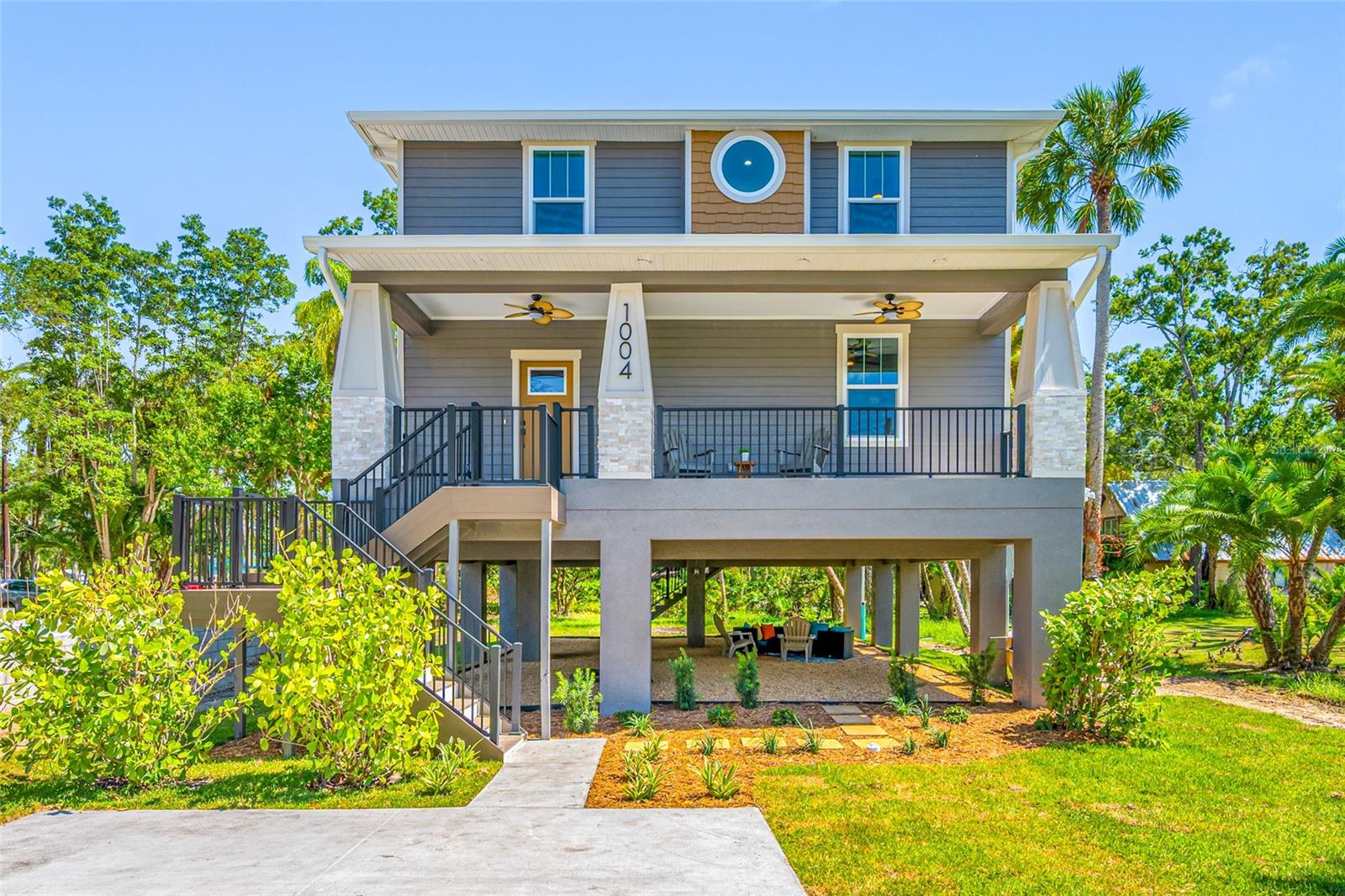 Seminole Heights neighborhood charm is exactly what this elevated 4 bedroom, 3 full bath bungalow offers. This is a one of a kind home, only a stone's throw from the Hillsborough River. Designed with personality and built for today's lifestyle!
This new construction home features a welcoming front porch, a huge under roof outdoor living space, custom stone accents on the exterior, and a perfectly curated interior. The floor plan offers a bedroom on the main level that could also double as an office, as well as a spacious living room open to the kitchen. The backsplash runs all the way to the ceiling and creates an elevated, designer look. The primary bedroom welcomes you in with a dramatic tray ceiling, warm vinyl plank flooring and a view of the palm trees through your hurricane impact windows. A feature wall along the staircase, a custom wet bar, a circular window and gold light fixtures all add to the individuality of this new build.
Built high and dry, the elevated design creates an incredible bonus space underneath the home. It's an expansive covered outdoor living area ideal for entertaining, relaxing, game days, or creating your own backyard oasis.
Located in one of Tampa's most desirable neighborhoods. Why settle for cookie cutter when you can have new construction with personality?
