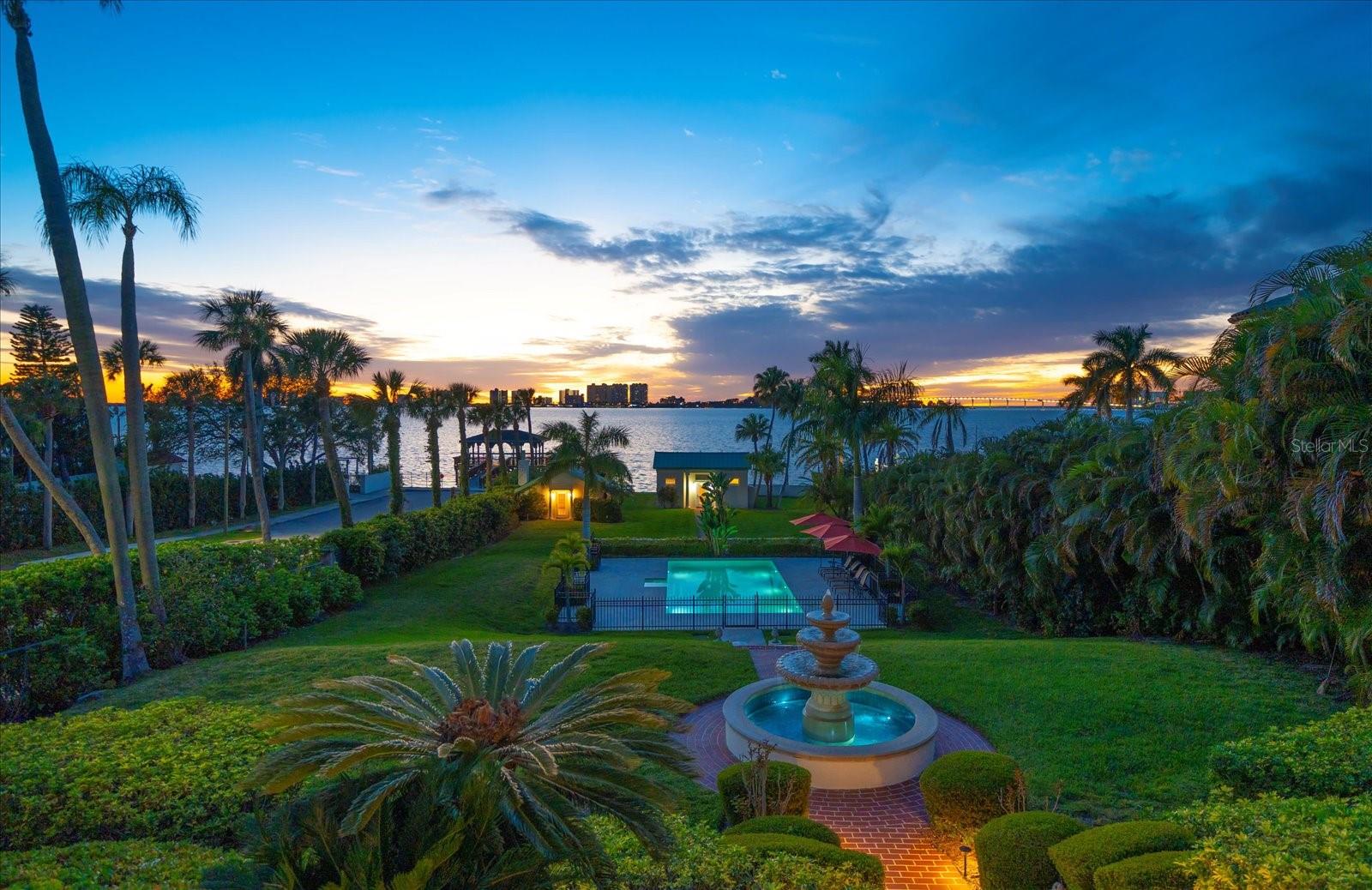 Discover a timeless treasure nestled within the historic Harbor Oaks neighborhood of Clearwater. This stunning waterfront residence, boasting a rich century-old legacy, has been meticulously renovated to marry its historic charm with contemporary luxury. From the moment you step inside, you're greeted by an atmosphere of refined elegance and quality craftsmanship. Architectural marvels abound, including intricate woodwork, majestic stone fireplace mantles, and pristine original wood floors that whisper tales of the past. The heart of the home lies in its spacious kitchen, where Saltillo tile floors, wood cabinets, and Corian countertops create a perfect blend of functionality and style. Step outside into the serene courtyard, complete with a soothing fountain, accessible from the kitchen for delightful al fresco dining experiences. Entertaining is effortless with a plethora of gathering spaces, including a grand dining room, inviting living room, cozy family room, and a versatile game room that promises endless enjoyment for family and friends. Ascend the grand stairway to the upper level, where an awe-inspiring primary bedroom suite awaits, offering breathtaking water and pool views through floor-to-ceiling French doors and a private balcony for moments of tranquil reflection. The ensuite bathroom is a haven of relaxation, boasting a walk-in closet with custom built-ins, a double sink vanity, and a luxurious walk-in shower. Your guests will feel pampered in the additional light-filled bedrooms, each offering ample closet space and a serene ambiance. Step outside into the lush oasis of the backyard, where swaying palms and a glistening pool beckon for leisurely afternoons of relaxation. A charming pool house and Casita offer additional convenience, providing ample storage for pool and water toys, as well as a private retreat for guests with a full bath and kitchenette. For the avid fisherman or boater, a floating dock, slip, and lift stand ready to facilitate countless adventures on the water. Beyond its exquisite amenities, this remarkable home holds a special place in Clearwater's rich history, residing in the city's first planned subdivision, founded in 1913. It's not just a home; it's a living testament to a bygone era, where every corner whispers stories of days gone by. Embrace the timeless allure of this waterfront masterpiece and become a part of Clearwater's storied past.