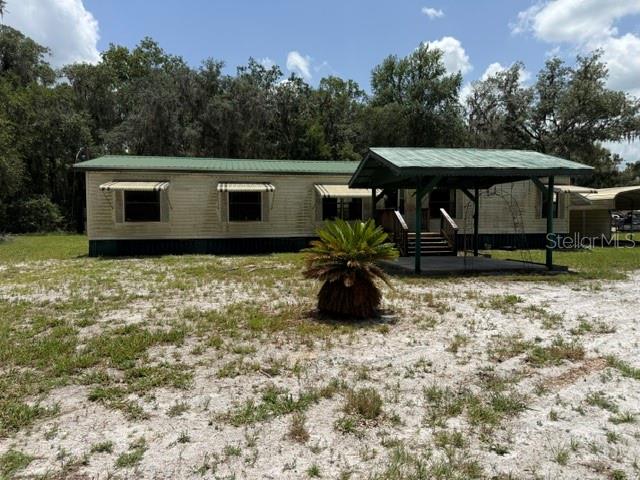 Enjoy country living with this spacious double-wide manufactured home situated on approximately 4 acres in the Bass Lake Ranches community of Citra, Florida. Offering 4 spacious bedrooms and 2 full bathrooms, this property provides plenty of room for family, guests, or a home office.
Inside, you'll find a formal living room and a separate formal dining room, providing ample space for entertaining and family gatherings. The open-concept kitchen offers abundant cabinet storage and overlooks the main living areas, creating a functional layout for everyday living. The oversized primary suite features a spacious en-suite bathroom complete with a relaxing garden tub, separate walk-in shower, and a large walk-in closet.
Step outside and enjoy the privacy and tranquility of country living. The property includes a small barn and an additional storage shed, providing ample space for equipment, hobbies, or extra storage. With 4 acres of land, there is plenty of room to expand, garden, or simply enjoy the outdoors.
Located near the Orange Lake, and the University of Florida IFAS Plant Science Research and Education Unit.
This property offers outstanding potential for buyers looking to customize a home to their own style and is being sold As Is. Don't miss this opportunity to own acreage in a desirable rural setting. Schedule your private showing today. All buyers must view the property before submitting an offer.