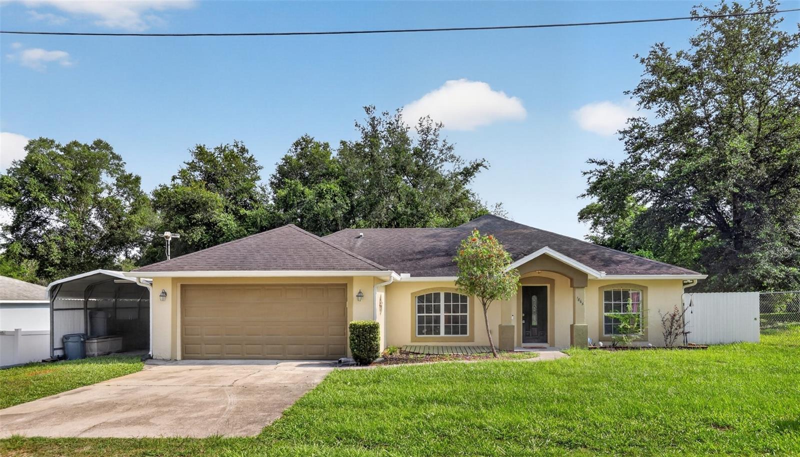 Country Living with Modern Convenience – NO HOA!

Welcome to this spacious 4-bedroom, 2-bath home offering the perfect blend of peaceful country living and everyday convenience. Situated on a quiet private dead-end street with very little traffic, you'll enjoy privacy while remaining just moments from shopping, dining, and major roadways. Just half a block away, you'll find access to the Cross Volusia Trail and nearby state park land, making it easy to enjoy walking, biking, and Florida's natural beauty.

Inside, you'll find beautiful 24" x 24" porcelain tile flooring throughout, helping keep the home cool while providing a clean, modern look. Originally built as a 3-bedroom, 2-bath home, a 2018 addition expanded the living space to create a true 4-bedroom, 2-bath layout, providing extra room for family, guests, or a home office. Approximately half of the roof was also replaced during the 2018 addition.
Outside is where this property truly shines! In addition to the attached 2-car garage, you'll find an impressive 11' x 25' metal carport—ideal for an RV, boat, additional vehicles, or recreational equipment. The detached 10' x 14' climate-controlled metal building is perfect as a workshop, hobby room, home office, fitness room, or extra storage.

The backyard is fully enclosed with a durable Miami-style metal fence, a premium feature rarely found in this area. For added peace of mind, the home is also equipped with generator connections already installed, making storm preparation quick and convenient.

Enjoy the benefits of private well and septic with no water bill, and best of all—NO HOA! Bring your boat, RV, work truck, or recreational vehicles without the restrictions often found in many communities.

Conveniently located just minutes from Downtown Orange City, Downtown DeLand, schools, shopping, restaurants, Publix, US 17-92, and Blue Spring State Park, this home offers the perfect balance of privacy, space, and convenience.

If you've been searching for a move-in-ready home with unique features, extra storage, room for all your toys, and a peaceful setting, this one deserves a spot at the top of your showing list!