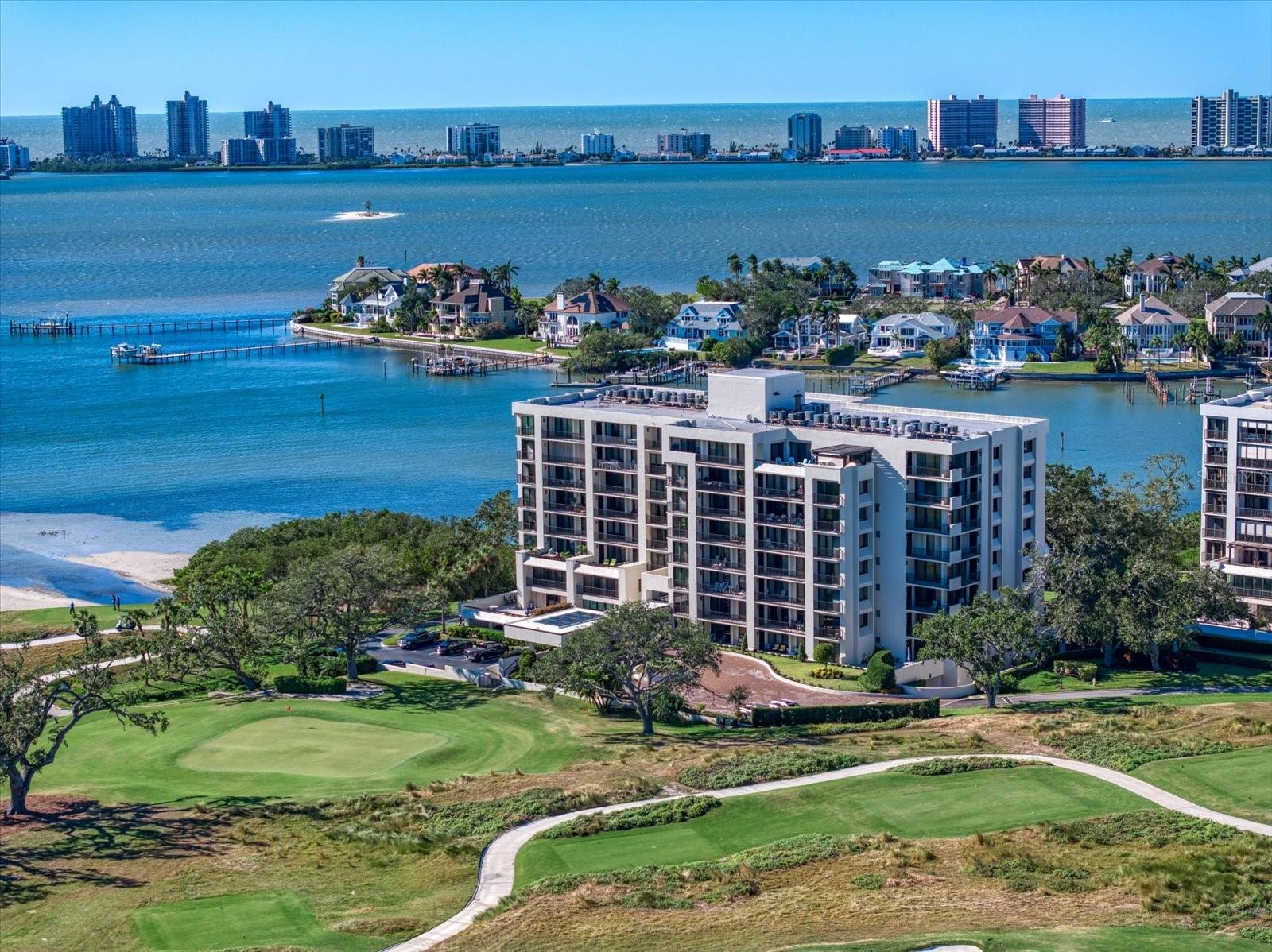 Welcome to South Garden, Building 4—an elegant retreat nestled behind the guarded gates of the prestigious Belleair Country Club. This desirable first-floor, move-in ready condo offers effortless access to the outdoors and stunning views of the lush golf course. Step inside to an open and bright floor plan freshly painted in soothing tones, featuring a sparkling white kitchen with stylish pendant lighting, a spacious dining and living room combo, and sliders that open to a private balcony overlooking the greens. An electric fireplace adds warmth and charm, while crown molding and wainscoting elevate the designer appeal. The spacious primary suite offers abundant closet space and a newly renovated ensuite with a sleek walk-in shower. The additional bedroom is equally inviting and shares a beautifully updated hall bath. Enjoy the resort-style community pool, secure building access, and close proximity to two private golf clubs, fine dining, boutique shops, and the area’s famous white-sand beaches. Live the Florida dream in this Belleair gem!