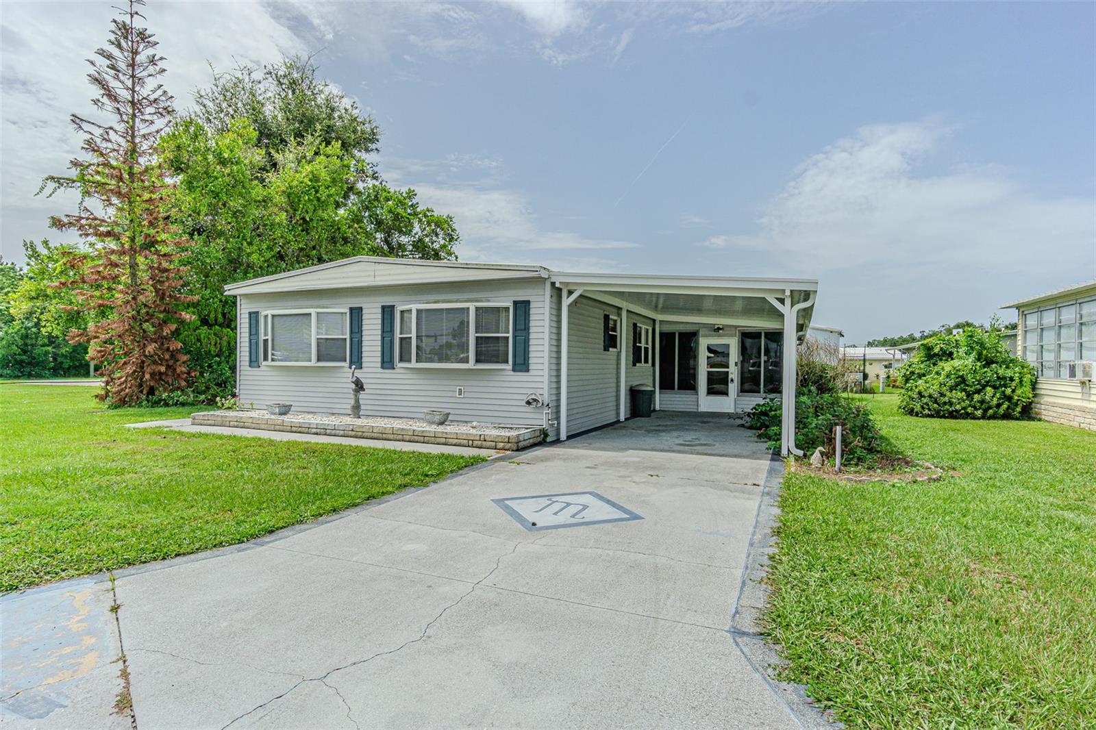 Welcome to easy Florida living in the desirable Valleydale Acres community!  No lot rent... You OWN the LAND!  This one owner, furnished 3-bedroom double-wide mobile home offers comfort, convenience, and exceptional value. The bright, sunny Great room is the perfect place to entertain family and friends with a door to a side deck to enjoy your morning coffee or relax with a good book!  Spacious floor plan includes a galley kitchen with a closet pantry, a formal dining area with a built-in china cabinet and a large primary suite featuring an oversized vanity area and separate water closet with a walk-in shower. Flex room with laminate floors can be a family room, formal dining room or fitness area. 2nd bedroom set up for guests while the 3rd bedroom is set up as a home office. A covered carport provides ample parking and the attached shed with workbench offers plenty of room for storage, hobbies, or projects. Ideally located in the growing city of Zephyrhills, you'll be just minutes from shopping, the hospital, pharmacies, restaurants, movie theaters, bowling, YMCA and major highways to Lakeland, Ocala, Orlando, International Airports & Beaches! Whether you're looking for a seasonal retreat or an affordable, low-maintenance home for year-round living, this is a must-see opportunity. CALL TODAY and discover everything this charming home has to offer!