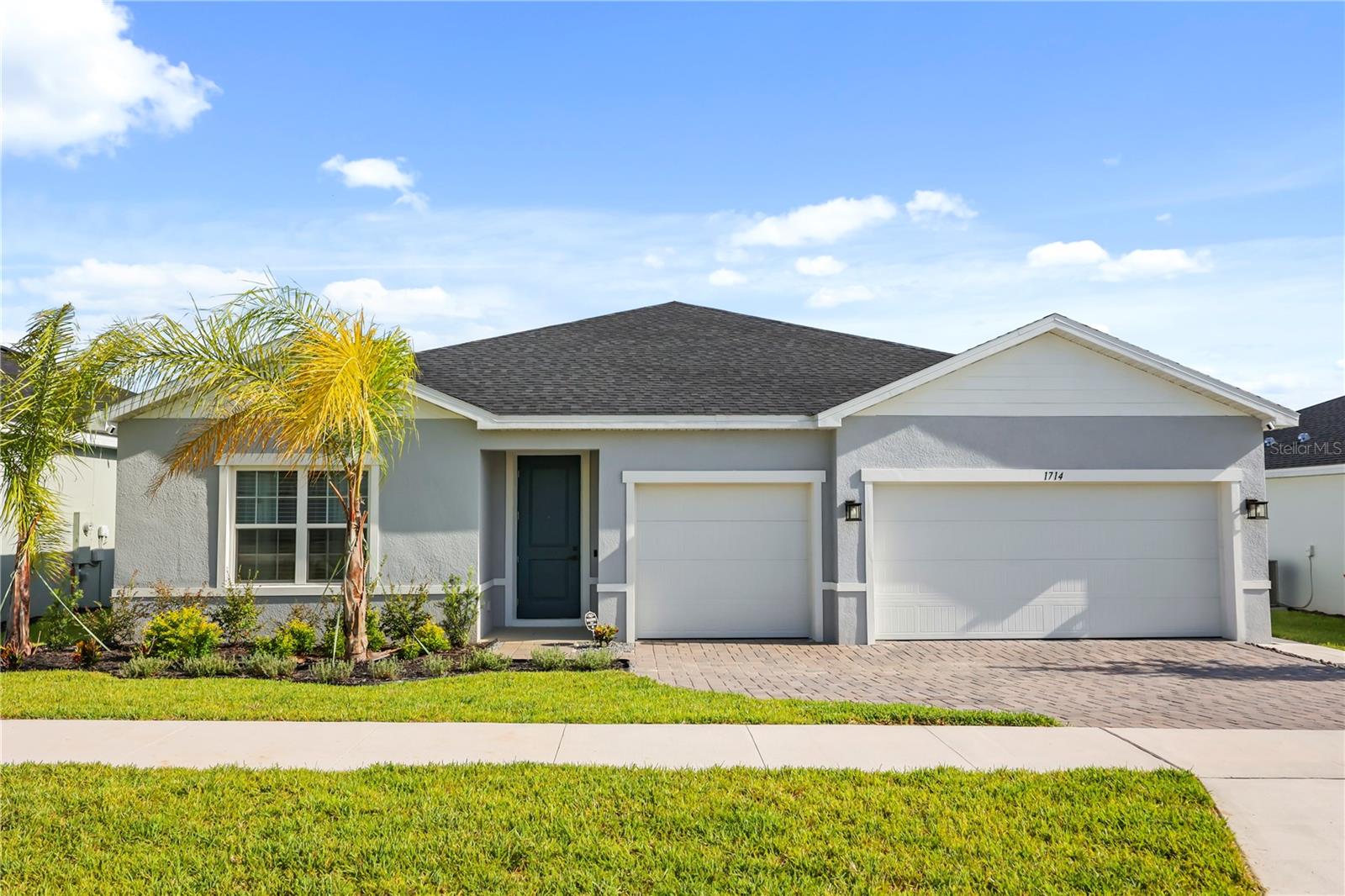 Why wait to build when you can move into this nearly new 2025 Ryan Homes residence? This beautifully maintained 4-bedroom, 3-bath home offers 2,565 heated square feet with a desirable split-bedroom floor plan, including a private guest suite with its own full bath—perfect for guests or multigenerational living. The spacious kitchen features a large island, walk-in pantry, and overlooks the open-concept living and dining areas. The primary suite includes a walk-in shower and generous walk-in closet, while tile flooring throughout the main living areas and carpeted bedrooms provide both style and comfort. Additional highlights include a three-car garage, paver driveway, irrigation system, dedicated laundry room with garage access, low quarterly HOA, and no CDD. Conveniently located near shopping, dining, schools, parks, and major roadways, this home offers all the benefits of new construction without the wait. Schedule your private showing today!