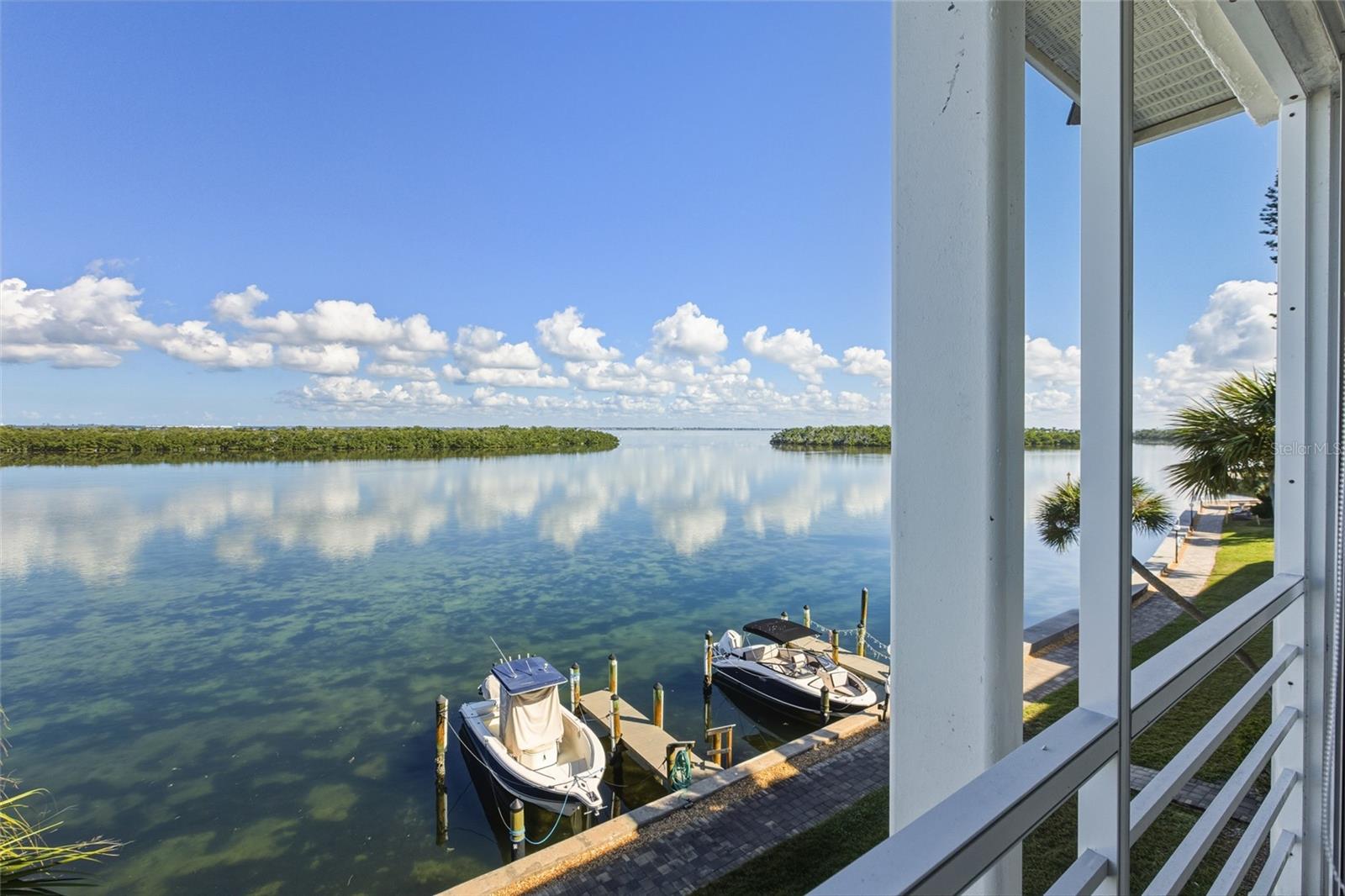 Enjoy tranquil, unobstructed Sarasota Bay views from this top-floor, two-bedroom, two-bath partially furnished residence in the desirable Longboat Harbour community. Fresh paint and updated lighting in some areas of the home enhance the bright, inviting interior, while comfortable living spaces offer peaceful water views from most rooms. The kitchen features stainless steel appliances, the hall bath has been refreshed with timeless finishes, and impact windows plus in-unit washer and dryer hookup add everyday convenience. Longboat Harbour offers resort-style amenities including multiple heated pools, fitness center with sauna, tennis, pickleball, shuffleboard, fishing pier, boating docks up to 34 feet, bike and kayak storage, on-site management, and deeded beach access just across the street with gated parking and facilities. Perfectly located mid-key for relaxed island living.