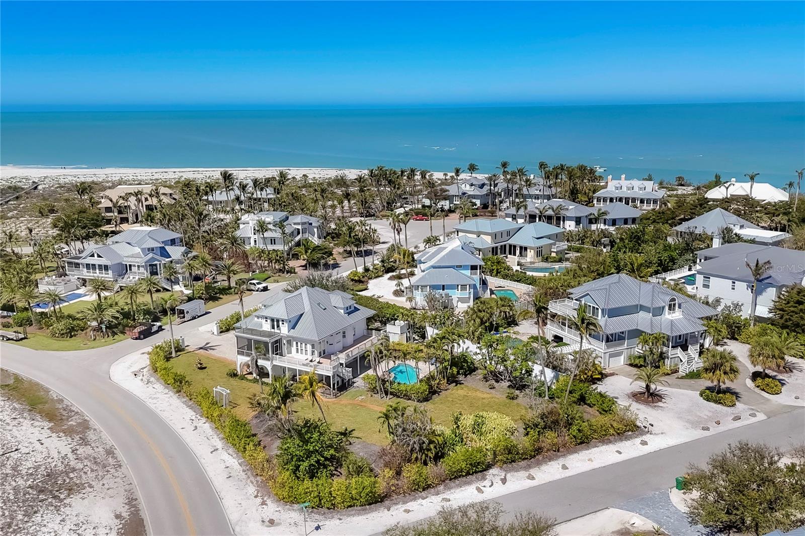 This exceptional custom-built home located on over half an acre offers protected lake views, beach access, and a serene coastal lifestyle in Boca Grande, Florida. Step inside to find 3,387 sq. ft. of thoughtfully designed living space filled with natural light, featuring impact glass sliding glass doors/windows and gorgeous wood floors throughout the main living area. Built by Bowen Construction in 2000, this modified and expanded “Seawatch” design seamlessly blends elegant living with modern comforts. The spacious living and dining area features a gas fireplace, custom built-in shelving, and two sets of sliding glass doors leading to a screened, exterior deck, perfect for enjoying unobstructed, tranquil water views. The Chef’s kitchen boasts a walk-in butler’s pantry with wine refrigerator and the kitchen features a new Sub-Zero refrigerator, double ovens, granite countertops, white cabinetry, and an eat-in dining area overlooking the private swimming pool and lake. This home offers 3 bedrooms and bathrooms, with one bedroom currently used as a den and a whole-home propane powered generator. The entire top floor is dedicated to the primary suite featuring an expanded layout, private deck with modern, clear glass railings providing full lake views. There are two dedicated offices, ideal for those who work remotely. The abundant outdoor space features a custom designed saltwater swimming pool and there’s tremendous parking opportunities for those who like to entertain including a two-car garage, dedicated golf cart garage, and add’l “under trellis” parking outside. This residence is minutes away from the Coral Creek Golf Club and the Boca Grande Club. Gulf Shores North is a quiet residential neighborhood located on the north shore of Boca Grande where beach access is deeded exclusively to homeowners, ensuring a serene and private coastal experience far from the crowds of public beach access points. The reasonable $620/year Homeowner’s Association fee covers the lake maintenance, minimizing carrying costs all while living in an upscale, gorgeous neighborhood with buried utilities. Call us today for your private tour!