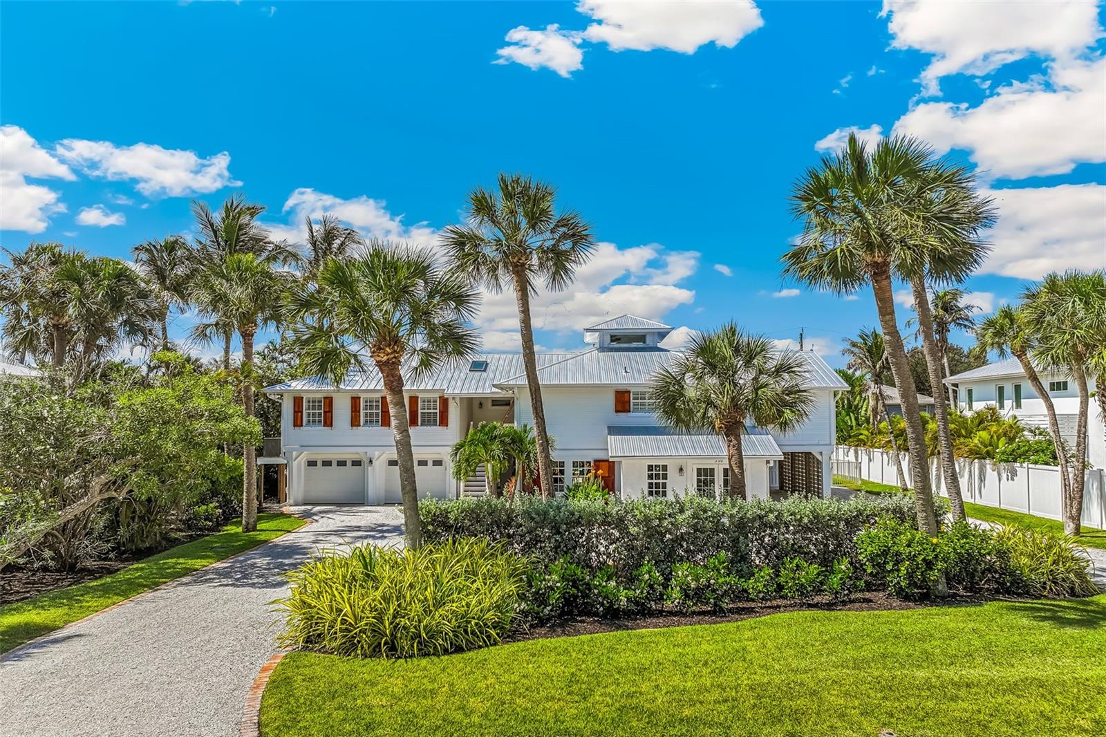 Located just south of Boca Grande village in Golden Beach, this beautiful pool home offers the trifecta of coastal living; comfort, and privacy, all near the beach. Set on a large, landscaped lot with banana trees, coconut palms, and tropical plantings, the property provides a peaceful island setting. The main level features three bedrooms, three bathrooms, a spacious den, sunny kitchen, vaulted ceilings, warm wood floors, open decks and a large, screened porch. Taken to the studs and rebuilt in 2004 by McHugh Porter Builders, additional highlights include an elevator, impact-rated windows and doors, a whole-house water filtration system, new metal roof and generator. The first floor has an 800SF guest quarters, an ideal space for family and friends with a private entrance and walk out to the pool. Plenty of room for the toys with a two-car garage, carport, boat parking and air-conditioned tackle room/storage. This property is complete with a large, heated saltwater pool and spa surrounded by elegant stone decking and an open covered patio.