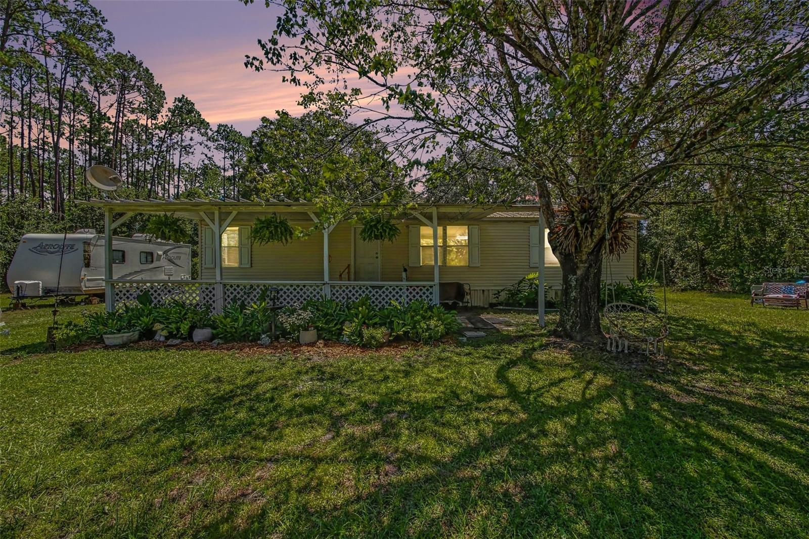 Enjoy pleasant country living in your fully fenced homestead property.  No HOA.  No lot rent. You own the land.  Over one acre of land in the rural peacefulness of Bunnell FL.  Cute and charming 3 bedroom 2 bath manufactured home with updated open concept kitchen including solid wood cabinets, quartz countertops, luxury vinyl plank flooring and new recessed lighting along with vaulted ceilings and skylights.  Septic pumpout 2026, water softener 2025. Brand new outdoor electrical. All information is deemed to be accurate but cannot be guaranteed. Bring the pets, the chickens and relax in your natural retreat.