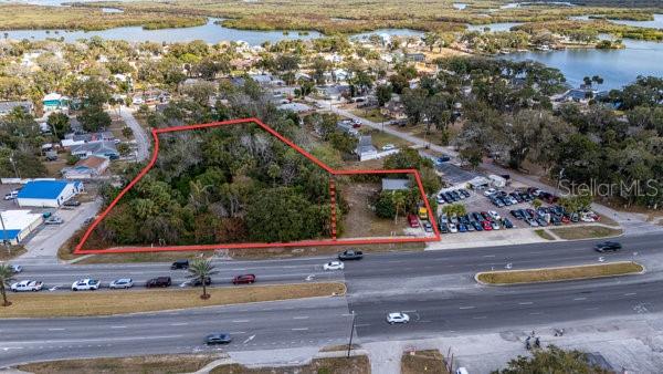 SUBJECT REAL ESTATE ENTAILS TWO COMMERCIALLY ZONED (MU) PARCELS ENCOMPASSING ~1.89 ACRES MAINTAINING A COMBINED ~310 LF OF ROAD FRONTAGE ON THE EAST SIDE OF US HWY 1 (S RIDGEWOOD AVE) IN THE HARBOR OAKS AREA OF PORT ORANGE. THE SITE IS CLOSE TO THE MAIN SIGNALIZED INTERSECTION & JUNCTION OF US 1 & STATE ROAD 5A (S NOVA ROAD) & EAST PALM AVENUE, WHICH IS WELL TRAVELED WITH AN AADT COUNT OF 28,000+/- VEHICLES. THE PARCEL AT 5919 S RIDGEWOOD CONSISTS OF ~64,380 SF OF MOSTLY WOODED LAND WITH REMNANTS OF AN EXPIRED 1924 STRUCTURE THAT STILL EXIST ON SITE. THE 5929 S RIDGEWOOD CONTAINS A TWO STORY DWELLING WITH GARAGE SPACE AND AMPLE PARKING ALL SITUATED UPON A ~17,860 SF PARCEL OF LAND DIRECTLY ABUTTING TO THE SOUTH. THE DWELLING WAS CONSTRUCTED IN 1934 AND ERECTED OF CB (PAINTED) AND NOW MAINTAINS A METAL ROOFING SYSTEM WITH ~720 SF OF INTERIOR SPACE THAT IS FULLY CLIMATE-CONTROLLED.