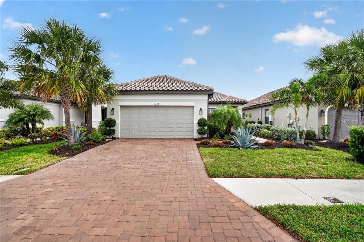 Move-in ready home in the Esplanade of Artisan Lakes where you will experience resort style Florida living!  This home features 3 bedrooms, 2-1/2 bathrooms and a 2-car garage.  The spacious home has an open floor plan and is light & bright!  Off of the family room is a screened lanai.  The kitchen features white cabinetry, stainless steel appliances, an island, a gas range, and quartz countertops.  The primary bedroom has an en-suite bathroom and a walk-in closet with built-ins.  The well cared for home also has plantation shutters.  The Esplanade of Artisan Lakes is a gated resort community offering two pools and two hot tubs. There are two amenity centers, a dog park, a fitness center, pickleball and tennis courts.  Enjoy the spa services, social events, wine tastings, cooking experiences and arts and crafts. Yard maintenance, irrigation, cable and internet are also included with your HOA dues.  This is a growing area with shopping, places to eat and a new medical center and hospital being built just a couple miles away. Beautiful beaches at Siesta Key, Anna Maria Island and St. Petersburg can all be reached in under an hour. Conveniently located near I-75 and I-275, this home provides easy access to Tampa, St. Petersburg, Bradenton, Sarasota, airports, dining, shopping, golf, and the sparkling Gulf Coast beaches.  This home is a must see and a pleasure to show!
