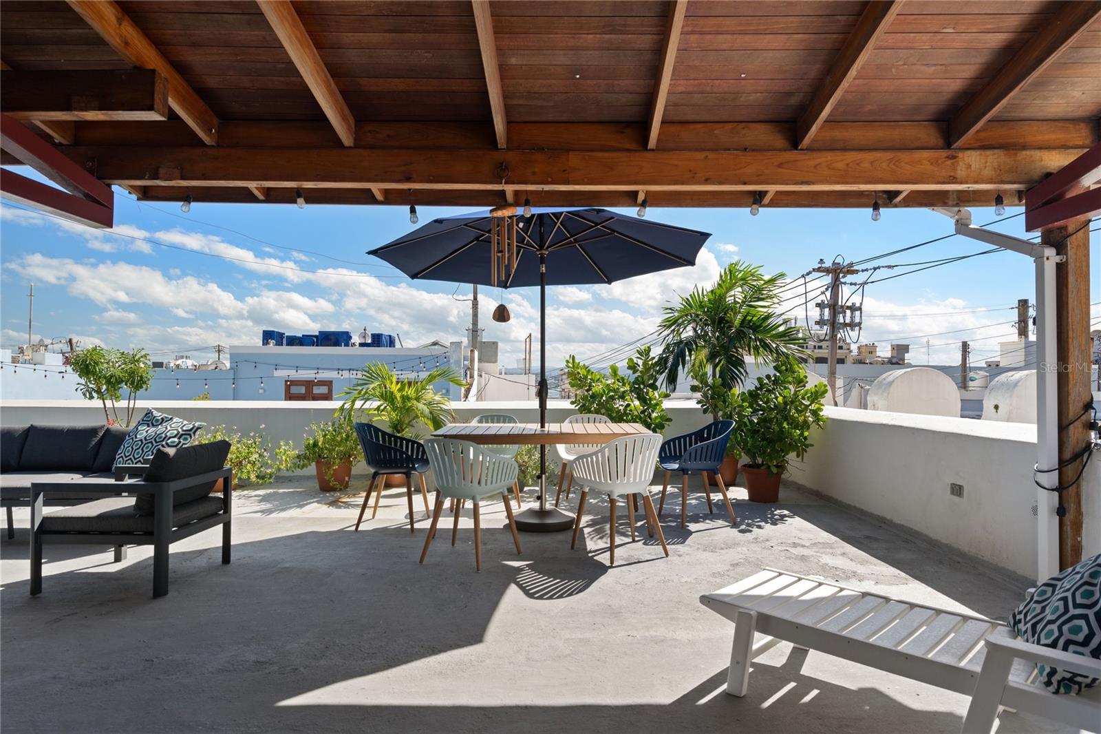Rare penthouse with tremendous terrace in the heart of historic Old San Juan. Located on the third floor of a beautifully restored historic building on iconic Calle Sol, this residence blends the timeless charm of Old San Juan with the modern convenience of elevator access, a rarity within the historic district. Offering 1,141 sq ft of interior living space and an expansive 883 sq ft private terrace, the apartment preserves its original character while incorporating refined modern finishes and contemporary living.The 2-bedroom, 2-bathroom apartment features beautifully exposed wooden beams, marble floors, and warm natural textures throughout. The open living, dining, and kitchen areas flow seamlessly through oversized wooden doors that open directly onto the terrace, creating a true indoor-outdoor living experience rarely found within the historic district. Whether entertaining guests, dining outdoors, or enjoying a quiet evening above the city, the terrace becomes a natural extension of the home.The kitchen is equipped with wood cabinetry, stainless-steel appliances, and a breakfast bar, while one of the bedrooms also enjoys direct terrace access. Natural light fills the residence, enhancing the warmth and openness of the interiors.
Located on iconic Calle Sol, just steps from celebrated restaurants, cafés, galleries, and the historic San Cristóbal fortress, the property offers both a vibrant lifestyle and the tranquility of one of Old San Juan’s most desirable residential streets.
The residence also offers exceptional investment appeal. Short-term rentals are permitted, and the property benefits from a Historic Property Certificate providing tax exemptions on property taxes and rental income. Solar panels add efficiency and modern functionality, making this penthouse equally suited as a luxury residence, second home, or income-producing investment within the walled city.