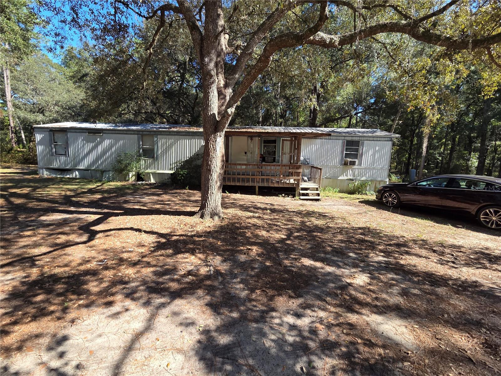 Enjoy peaceful country living with this 3 bedroom, 2 bathroom mobile home. Sitting on over an acre lot, the mature trees and open surroundings provide a sense of privacy while maintaining easy access to nearby amenities. Located just minutes from Melrose and Lake Santa Fe, this property offers the best of rural living with convenient access to Gainesville (approximately 40 minutes) and Jacksonville and St. Augustine (just over an hour).