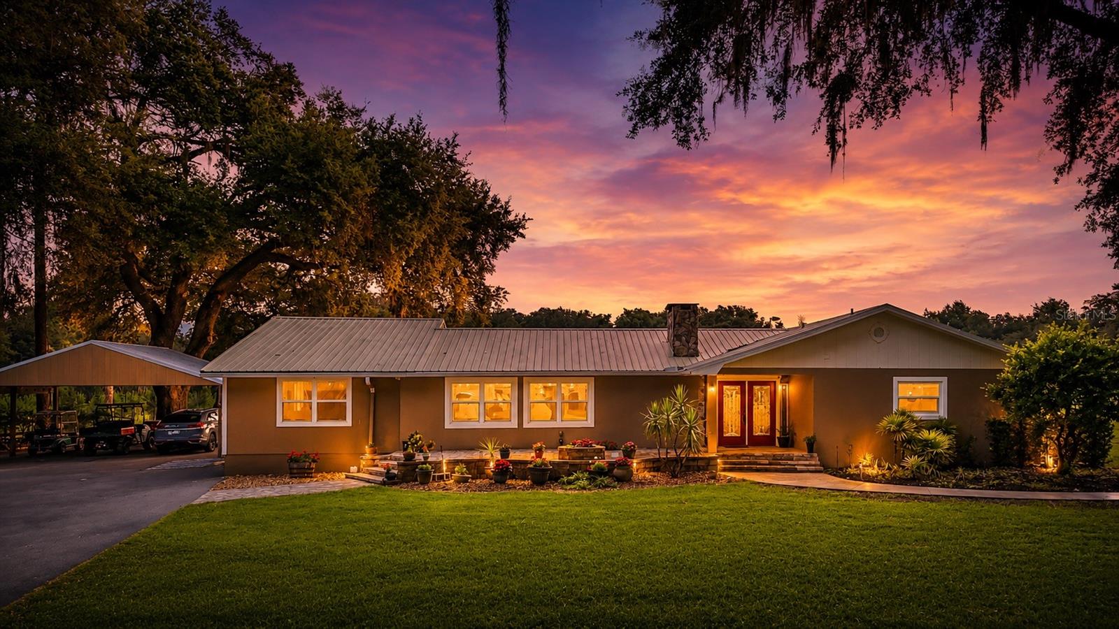 Virtually Staged. A true Florida homestead estate offering privacy, income potential, and exceptional infrastructure on 16.8 fully fenced acres.

This unique property features three separate residences. The primary home offers over 1,900 square feet with 3 bedrooms, 2 full baths, spacious living areas, and extensive upgrades throughout. Two additional rental-ready living quarters provide excellent flexibility for guests, multi-generational living, or income production: a 2-bedroom, 1-bath apartment with approximately 540 square feet, full-size kitchen with granite countertops, open-concept living area, private entrance, and laundry; plus an upper-level 1-bedroom, 1-bath apartment with kitchenette, private entrance, and laundry.

As you enter through the private electric gate, a paved circular driveway welcomes you to this impressive estate. The grounds include a serene pond with dock, two newly installed pickleball courts, a stable/chicken coop with storage and dedicated bathroom, and a decorative utility shed housing the water filtration system. Approximately 4,000 planted pine trees provide agricultural tax benefits and future harvesting potential.

For hobbyists, entrepreneurs, and equipment storage, the property includes a massive 24' x 40' climate-controlled pole barn featuring its own HVAC system, water heater, extensive shelving, abundant lighting, two roll-up doors, and 20-amp outlets every 10 feet. An adjoining RV carport offers water service, storage, and 50-amp electrical hookup.

Designed for efficiency and self-sufficiency, the estate is equipped with 30 high-efficiency solar panels, a battery backup system, a whole-house 20kW Generac generator, and a 500-gallon fuel tank with pump.

Inside the main residence, the open-concept kitchen, dining, and living areas are anchored by a stunning natural limestone wood-burning fireplace that extends into the foyer. The kitchen features solid wood cabinetry, stainless steel appliances, a gas range (2020), granite countertops, and a breakfast bar. Additional highlights include hurricane-rated windows, crown molding, custom beam accents, remote-controlled blinds, HVAC replaced in 2020, metal roofing with gutters, a spacious walk-in pantry, and a light-filled family room.

The primary suite offers a luxurious retreat with a large walk-in closet featuring built-in shelving and an updated en-suite bath. Outdoors, enjoy an above-ground pool with composite decking, a covered patio with grilling station and built-in storage, plus beautifully landscaped grounds enhanced by pavers, lighting, and irrigation.

With more than $350,000 in recent improvements, this one-of-a-kind property combines modern conveniences, agricultural opportunity, recreational amenities, and multiple income-producing residences, all in a private country setting.