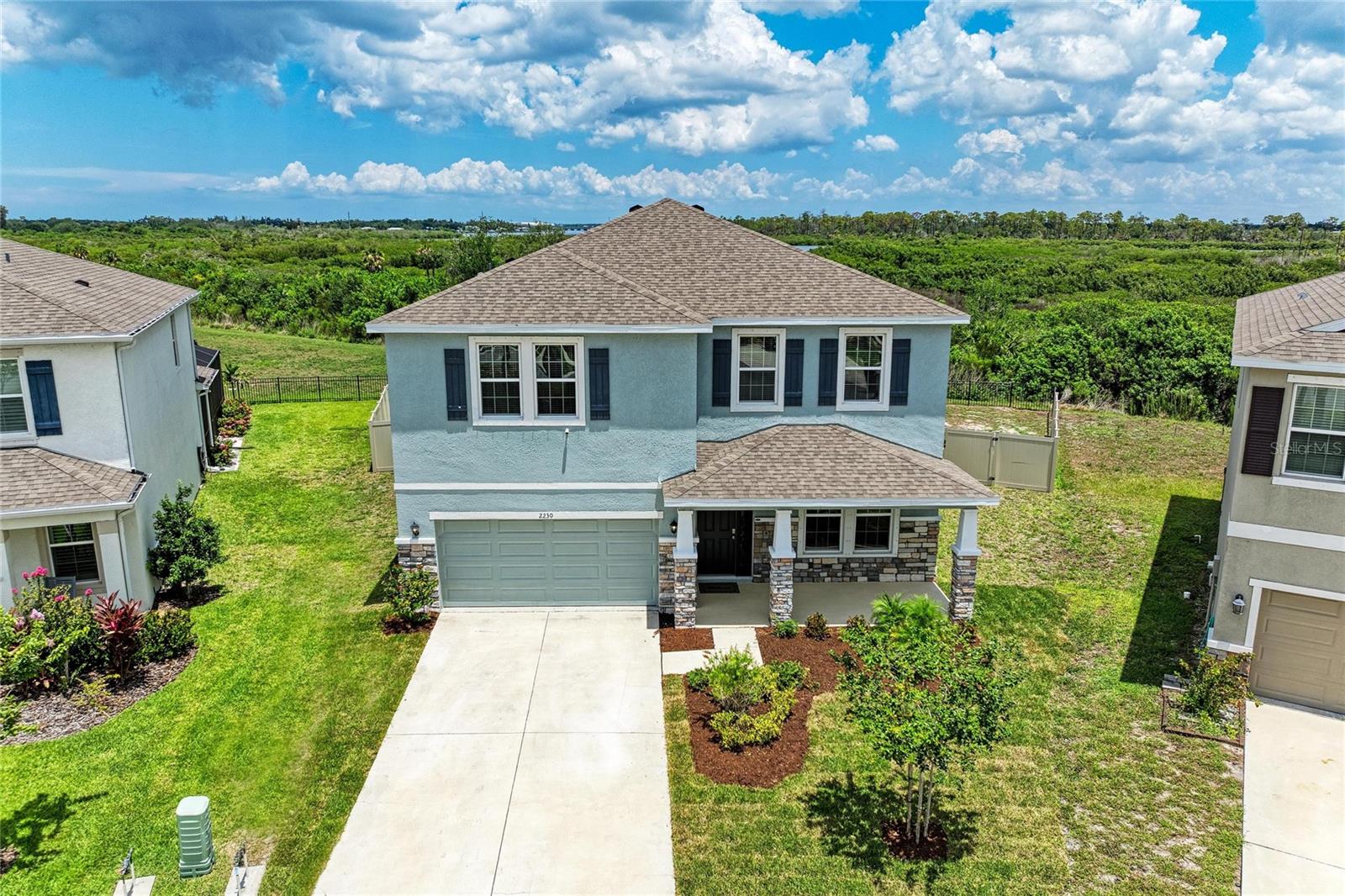 Virtually Staged. Immense privacy, beautiful views of nature, and spacious living can be yours. Come see this beautifully-maintained home in Bradenton's Evergreen Estates. This energy-efficient two-story concrete block home is situated on a pie shaped preserve homesite and ideally located on a quiet cul-de-sac. Step inside to over 3,360 square feet of modern living space with four bedrooms, three full bathrooms, a private office, a bonus room, and loft. The open-concept floor plan features a gourmet eat-in kitchen with stainless steel appliances and plentiful cabinetry, perfect for a home chef and family get-togethers. Downstairs, you’ll find a versatile bedroom that can serve as a guest suite or second office. Upstairs, you’ll find even more room to enjoy, including a spacious bonus room, a convenient laundry room, and an elegant primary retreat featuring an oversized walk-in closet, and a luxurious ensuite bath with a garden soaking tub, separate shower, and dual vanities. Evergreen Estates is a gated enclave with close proximity to shops, restaurants, and parks. Residents enjoy a pool, picnic pavilion, and children’s playground area.
