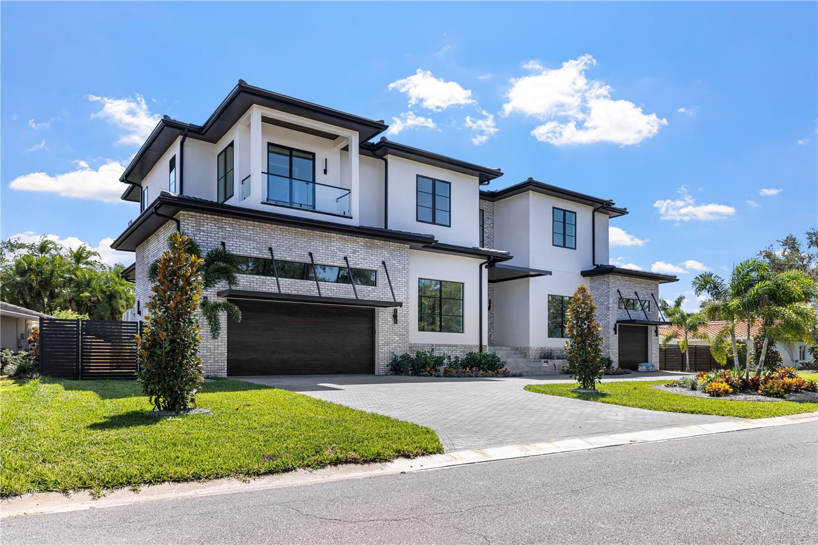Step into elevated luxury living with this stunning 5-bedroom, 6.5-bath custom estate built for an executive family, featuring 12' ceilings on the first floor, 10' ceilings on the second, and a grand luxury design across over 5,483 sq ft of impeccably crafted living space. A dramatic 22-foot entry with overhead skybridge, oversized windows, and custom iron doors welcomes you, complemented by four Palecek Corsica pendant lights, backlit LED mini-tray grid, and marble-tiled bench area, creating a first impression that is truly unforgettable. Signature design elements, including custom decorative walls and high-end finishes throughout, set the tone for sophisticated living.

The heart of the home is a gourmet kitchen showcase, complete with Wolf SubZero appliance package, built-in coffee maker, wall double oven with Wolf's convection system, custom hood, and a quartz waterfall island with integrated sitting area and oversized sink. Luxury skinny shaker cabinets (Waypoint Maple Almond) provide durable, elegant storage, while a butler's pantry includes an additional full-size refrigerator and wine cooler. A custom wine cabinet is seamlessly integrated into the dining room for effortless entertaining.

The great room living space features soaring 14' ceilings, a custom built-in fireplace with fluted wood and large-format porcelain tile surround, and expansive sliders opening to the pool and outdoor entertaining areas. The executive study dazzles with water views, full-wall built-ins, and Arhaus Bronze Arrow accents, while the powder and pool baths are adorned with leathered porcelain, marble mosaic, oversized quartz countertops, and unique design elements for a refined experience.

The luxurious owner's suite offers a sitting area with linear fireplace and water views, a spa-inspired bathroom with dual rain shower heads, floating cabinets, 6cm quartz countertops, and oversized linen closet. The master closet includes a full shelving system, island, and bench for seamless organization. Additional bedrooms and an oversized game room provide space for family and guests alike.

Step outside to a resort-style backyard featuring a large, heated pool and spa with spillover waterfall, integration of foxtails, and upgraded outdoor kitchen by Artisan. The over 15,000 sq ft estate lot provides privacy and grandeur, with a metal and stained wood fence, lush landscape package, planters, salt-and-pepper granite accents, and ambient lighting. Outdoor living spaces include pool baths, frosted-glass doors for easy lanai access, and multiple entertaining zones for family and guests.

Smart-home amenities include a Generac whole-home generator, hurricane-rated casement windows throughout, and pre-wired EV chargers. The oversized circular paver driveway with split 3-car garage completes the estate's convenience and luxury. Every detail, from high-end finishes to thoughtful living spaces, is designed for comfort, style, and sophisticated Florida living.