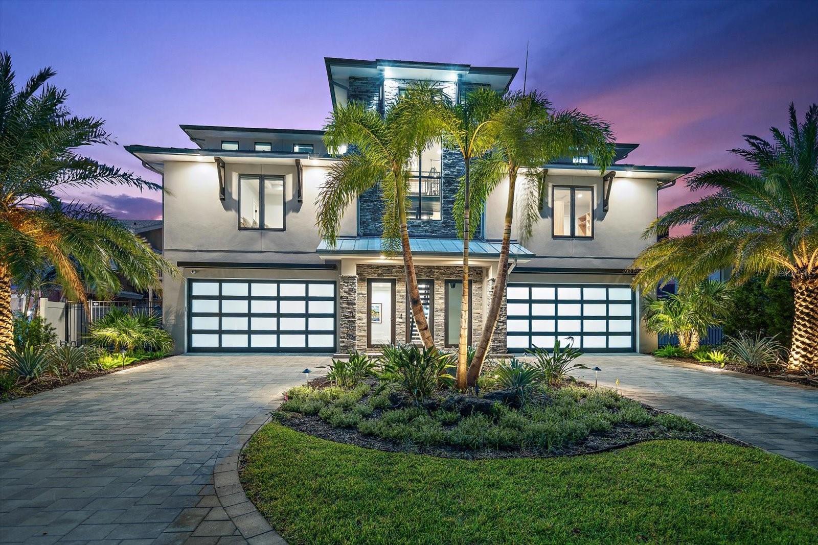 Spectacular customized new residence! With the final touches complete, this recently constructed custom home offers a move in ready experience, bypassing the usual challenges and waits associated with new construction. Dare to compare this new modern coastal property built by renowned Campagna Homes of Tampa Bay. Expertly engineered for peace of mind and constructed with uncompromising quality, every detail of this smart home reflects thoughtful craftsmanship, cutting-edge design, setting a new standard for luxury waterfront living. 
Situated on a premium waterfront lot with breathtaking uninterrupted water views from the intracoastal to the blue waters of the Gulf of Mexico, this home offers the pinnacle of Florida living. An atrium entry is stunning! Step inside to soaring ceilings and a dramatic floating staircase accented by a bold blue agate feature wall. The expansive great room, kitchen, and dining area flow seamlessly to the outdoors through accordion-style doors that fully open to a wide verandah overlooking panoramic views of the Intracoastal Waterway, dotted with spoil islands and framed by Caladesi and Honeymoon Islands. The kitchen and bathrooms throughout the home are elevated, artistic, and curated with intention. Natural stone, marble, dramatic tile, designer lighting, bespoke mirrors and plumbing fixtures were carefully selected to create a cohesive sense of style and sophistication. The chef’s kitchen is a showpiece, featuring three ovens, a warming drawer, six-burner gas range with pot filler, stainless steel hood, wine fridge, and ice maker—all crafted to both impress and perform.
Additional highlights include a richly appointed glass-enclosed study with custom-built-ins, a luxurious home theater (or 4th bedroom), and a saltwater pool perfect for entertaining or peaceful relaxation. The dock offers a covered slip and a separate low-profile platform for easy kayak and paddleboard launch or a jet ski. A whole house generator, elevator and safe room add to the list of features which make this residence exceptional.  
Located 30 to 45 minutes from Tampa International Airport, St. Pete, and Clearwater, this property is your gateway to Gulf Coast beaches, nightlife, arts, and professional sports, and best of all, just a golf cart ride to the charm of Dunedin, one of Florida's most beloved coastal towns.