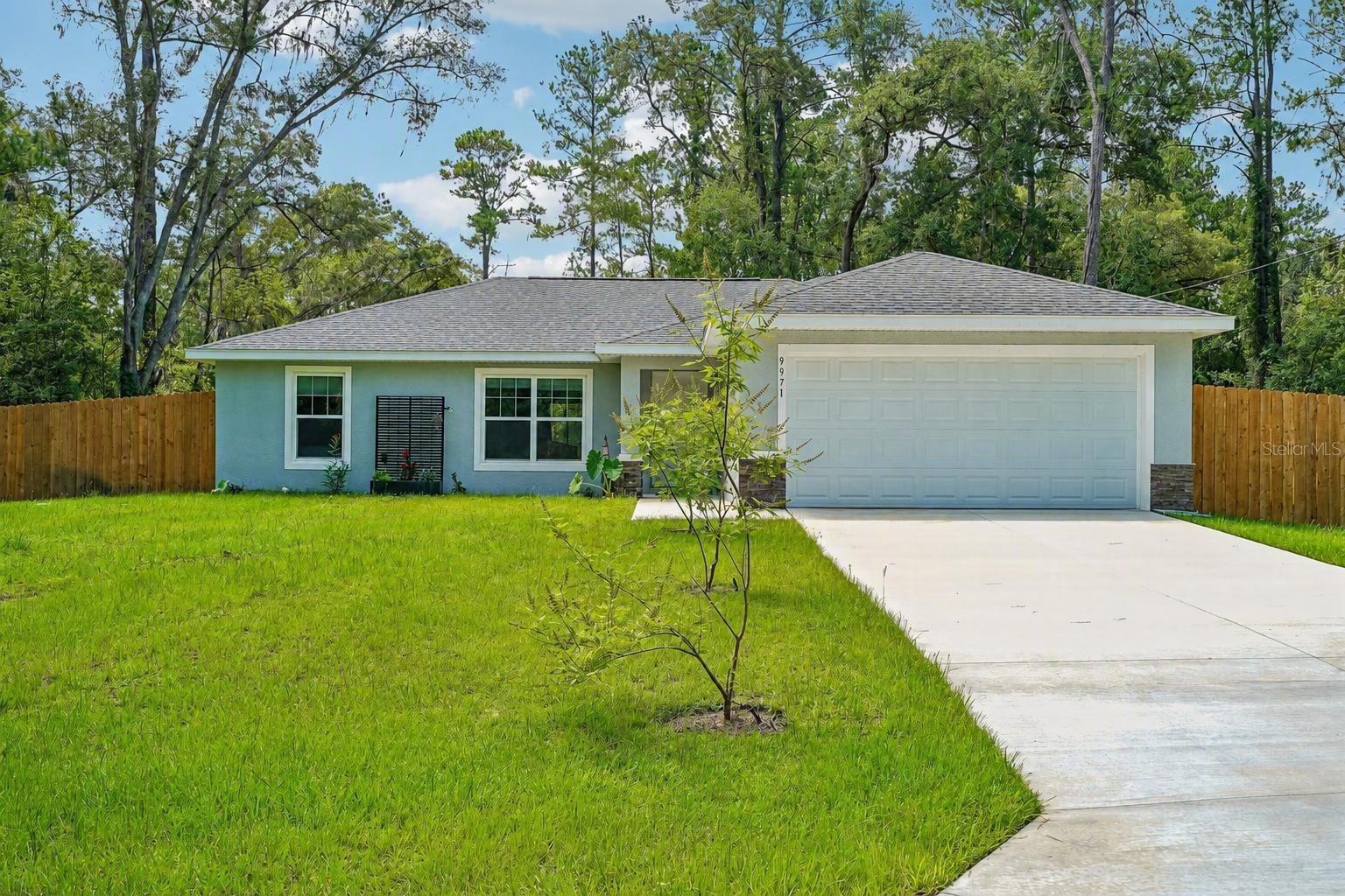 Better than new and barely lived in! Built in 2025 and purchased as a vacation home, this beautiful Citrus Springs residence has been occupied for less than a year and remains in exceptional condition. Offering 3 bedrooms and 2 bathrooms of thoughtfully designed living space, this move-in ready home provides all the benefits of new construction without the added expense and hassle of completing post-closing improvements. The open-concept floor plan is perfect for both everyday living and entertaining, featuring a spacious living area that flows seamlessly into the kitchen and dining space. The kitchen is equipped with stainless steel appliances, ample cabinetry, and plenty of workspace. Luxury vinyl plank flooring enhances the main living areas, while the bedrooms offer comfortable carpeting and the bathrooms feature durable tile flooring. The spacious primary suite includes a walk-in closet and private bath, and the split-bedroom layout provides added privacy for family members and guests. An indoor laundry room adds convenience to daily life. Unlike many newly constructed homes, this property already includes valuable upgrades that can save buyers thousands of dollars. The backyard is fully fenced, providing privacy and a secure space. The home is connected to public water for household use and also features a separate well dedicated to irrigation, helping reduce water costs while keeping the landscaping looking its best. Situated on a flat homesite, the property offers excellent usability and plenty of room for outdoor enjoyment. Located in the desirable Citrus Springs community with no HOA fees, residents enjoy larger lots, a peaceful setting, and convenient access to some of Florida's best outdoor recreation. Just minutes away, you'll find the Withlacoochee State Trail for biking, walking, and horseback riding, along with the crystal-clear waters of Rainbow Springs State Park and the Rainbow River for kayaking, tubing, paddleboarding, swimming, and boating. The Nature Coast is also known for world-class fishing, boating, scalloping, golf courses, and waterfront dining. Conveniently located near shopping, restaurants, medical facilities, and everyday conveniences in Dunnellon, Crystal River, and Ocala, this home offers the perfect balance of tranquility and accessibility. Why wait months for a new build when you can own a nearly new home that already has the upgrades completed? Schedule your private showing today and discover everything this exceptional Citrus Springs property has to offer.
