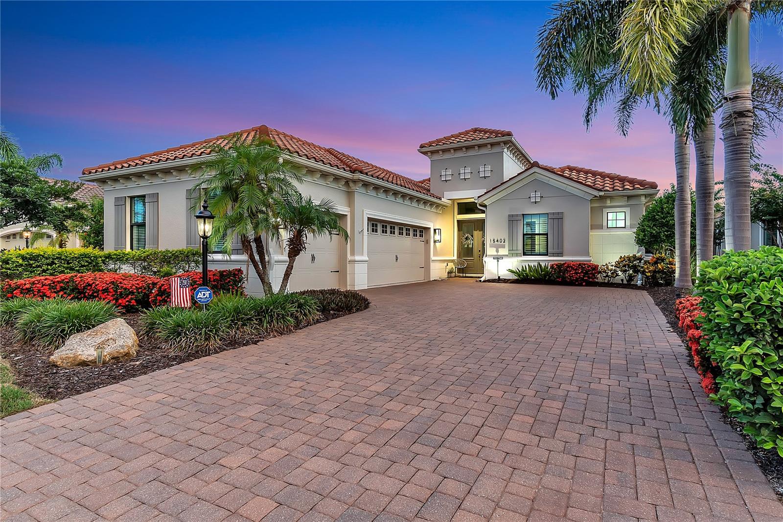 Step into refined luxury at 15402 Castle Park Terrace, an impeccably upgraded Belle Vista model by Neal Signature Homes. Positioned on a premier lot in the prestigious enclave of Country Club East, this 3-bedroom, 3.5-bath, 3-car garage estate boasts expansive, panoramic water and golf course views from the moment you arrive.

A grand double-door entry reveals a sweeping hallway that frames immediate, unobstructed sightlines of the lush fairway. The interior exudes a spa-like elegance, featuring fresh neutral paint, gorgeous plantation shutters, and premium tile flooring throughout—completely free of carpet. Warm wood-tone tile accents anchor the main living spaces and bedrooms, complemented by custom lighting and fans. Designed for effortless entertaining, the grand living area flows seamlessly into a formal dining space, highlighted by custom window shades. The centerpiece for hosting is a phenomenal custom bar, complete with quartz countertops, stone accents, built-in shelving, ambient lighting, and a wine refrigerator.

The light, bright, and masterfully appointed kitchen features miles of quartz counter space, a massive central island, and quiet-close cabinetry with pull-outs and custom hardware. Culinary enthusiasts will appreciate the GE Profile gas cooktop, oven, and microwave, complemented by a brand-new Bosch dishwasher.

The spacious primary retreat offers a private sanctuary with serene water and golf views. It features dual walk-in closets with custom built-ins—including a specialized lockable jewelry door—and a spa-inspired bath with quartz dual vanities, a large walk-in shower, and a private water closet. A dedicated home office impresses with extensive built-ins. Guest accommodations include a spacious bedroom with a private en-suite bath situated at the front of the home, plus a second large bedroom with a walk-in closet and a beautifully updated guest bath featuring an upgraded glass enclosure over a porcelain tub. The meticulously designed laundry room includes quartz counters, built-in cabinetry, a sink, and a drying rack.

Step outside to a spectacular outdoor living area. The heated pool and spa are powered by an upgraded Pentair system, surrounded by a lanai equipped with a motorized SPF sunshade and a natural gas hookup ready for an outdoor kitchen. A dedicated pool half-bath, easily accessible from the lanai, features a new vanity, quartz counters, and custom paint.

This home is fortified with incredible infrastructure upgrades: a Generac whole-home generator, a brand-new AC system, a tankless water heater, and a whole-house water softener with a drinking purifier. The exterior has been recently sealed and painted, the home is protected by an ADT security system, and the 3-car garage features insulated doors. Located mere minutes from Waterside Place, Downtown Lakewood Ranch, and Sarasota’s world-class beaches and cultural mecca.