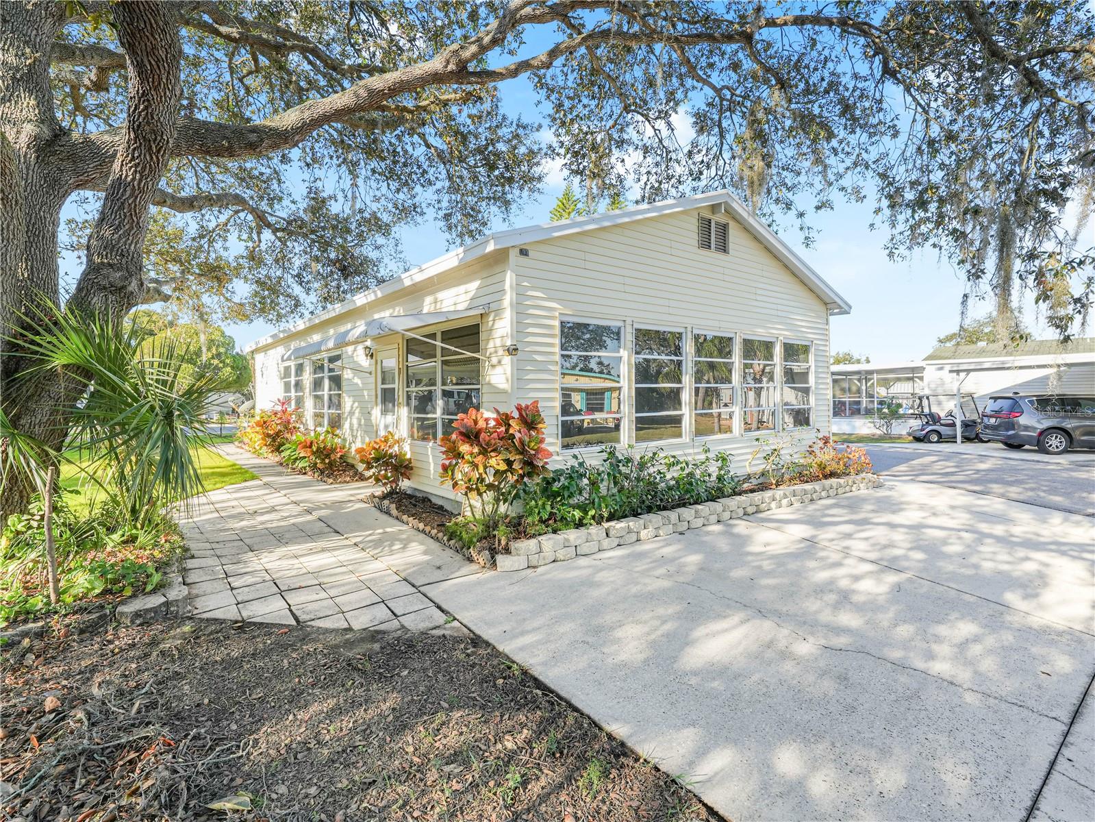 This spacious home in the premier 55+ gated community of Saddlebag Lake Resort, where you own the land, is just waiting for its new owner! Situated on a shaded corner lot, there is plenty of parking with a driveway at both the front and the rear of the home. Upon entering the front door, you'll find a large family room that's perfect for entertaining company, with a table for playing cards and comfortable seating for enjoying conversation. The huge living room is outfitted with an office nook and daybed, in addition to the new La-Z-Boy recliner. You'll love the kitchen, with it's double sinks, ample counter space and cabinets, and even a window seat. The bedroom comes complete with two electric-adjustable single beds. There's even a laundry closet with a washer and dryer stack. When you're ready to venture out, check out all this pet-friendly resort has to offer! There's a clubhouse where you can get to know your neighbors, a heated community pool, hot tub, rec room with pool tables, fitness equipment and saunas, tennis, pickle ball and shuffleboard courts, horse shoes, a driving range, and a beach house with a fully equipped kitchen that you can reserve for private lakefront parties. Of course, you can access the lake at the community boat ramp to go boating and fishing. You will live like you're on vacation every day! All of these amenities are included in the low quarterly HOA dues, as are your water, sewer and trash pickup - what a deal! There's even a post office on site, so you won't have to leave the resort to get your mail. You owe it to yourself to check this out before it's gone, so call now for your private tour!