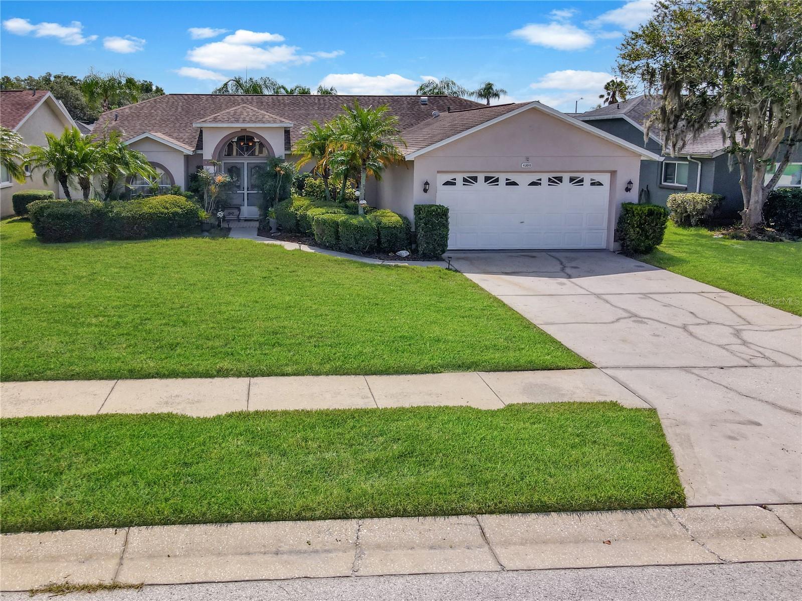 Florida living at its best! Welcome to this beautifully maintained 3-bedroom, 2-bath pool home in sought-after Millpond Estates. From the moment you step inside, you'll appreciate the soaring vaulted ceilings, open split-bedroom floor plan, and abundant natural light that fills the living spaces.
The updated kitchen features granite countertops, stainless steel appliances, a breakfast bar, and overlooks the spacious family room, perfect for entertaining or everyday living.
The primary suite offers a walk-in closet, an updated en-suite bath with granite countertops, vessel sinks, a garden tub, and separate shower. Sliding glass doors from both the primary suite and the living room open to the screened lanai, creating a seamless connection between the indoor living spaces and your private outdoor retreat. The guest bathroom has also been tastefully updated with granite countertops and vessel sinks and provides convenient direct access to the pool.
Step outside to your own backyard oasis. The custom PebbleTec saltwater pool is surrounded by an expansive brick paver patio, tropical landscaping, and plenty of space for outdoor dining, relaxing, or entertaining. Whether you're enjoying your morning coffee, hosting family and friends, or unwinding after a long day, this outdoor living space is designed to be enjoyed year-round.
Additional updates include a 2018 roof, 2021 A/C, updated Hayward saltwater pool system, and a lifetime PebbleTec pool finish. Millpond Estates offers a community pool, clubhouse, sidewalks, and a low HOA. Conveniently located near shopping, dining, medical facilities, parks, Gulf beaches, and with easy access to the Suncoast Parkway, Tampa, and Orlando, this home offers the perfect combination of comfort, convenience, and the Florida lifestyle.