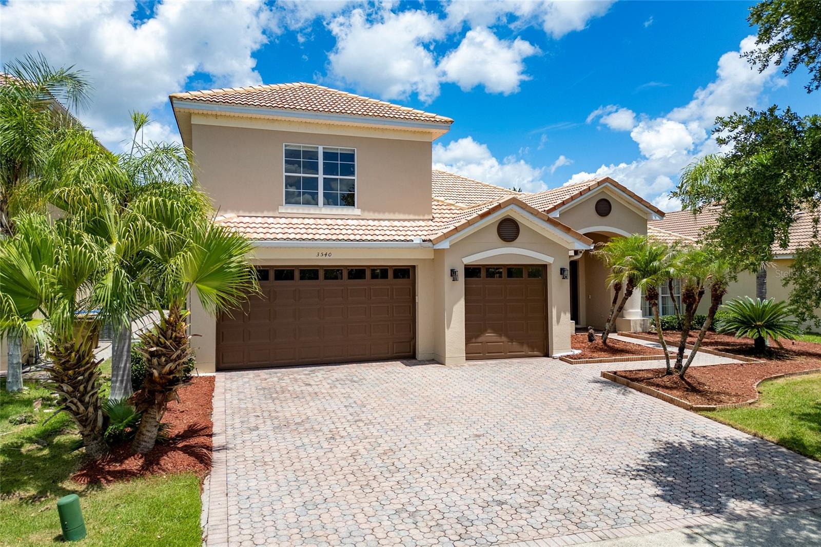 Welcome to this stunning, Mediterranean-inspired 5-bed, 4-bath masterpiece in the gated Bellalago community, offering over 3,000 sq. ft. of thoughtfully designed living space in Kissimmee’s premier lifestyle neighborhood. Step inside to an open floorplan with all-tile flooring, fresh interior paint, and designer light fixtures. The chef’s kitchen is well-appointed with modern cabinetry, granite countertops, stainless steel appliances, and custom backsplash, creating a bright, modern heart of the home. The main-level primary suite is a private retreat complete with natural light, walk-in closet, and spa-style bath with garden tub and separate shower. A versatile upstairs flex space with full bath offers endless possibilities — home office, media room, guest suite or play area. Outdoor living is effortless on the screened-in patio overlooking lush preserve, ideal for relaxing or entertaining. Additional highlights include a three-car garage with tile floor, cathedral ceilings, and split bedroom plan. Life in Bellalago means resort-style amenities — two clubhouses, community pools with slides, tennis & pickleball courts, fitness center, walking trails, boardwalk over Lake Toho with fishing piers and boat docks, on-site restaurant, and 24/7 manned gates for peace of mind. Convenient to shopping, dining, schools and major attractions, this home offers a perfect blend of luxury, comfort and community living.