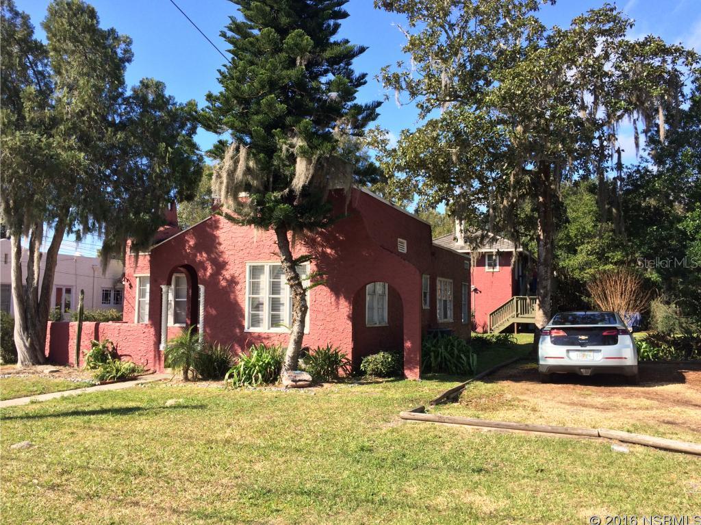 Investor Special! Mediterranean revival income property features; 3Bed/2Bath main house with detached 2 story building offering 2 separate 1BR/1BA units. Main house has hard wood floors, original windows, fireplace and recently renovated kitchen and bathrooms. Detached 2 story building also has newer kitchens and baths in both units. Downstairs unit offers a screened porch, while the upstairs offers a deck overlooking the large yard with mature foliage. Live in the home and let the apartments pay for your mortgage!! Huge lot with plenty of room to expand!